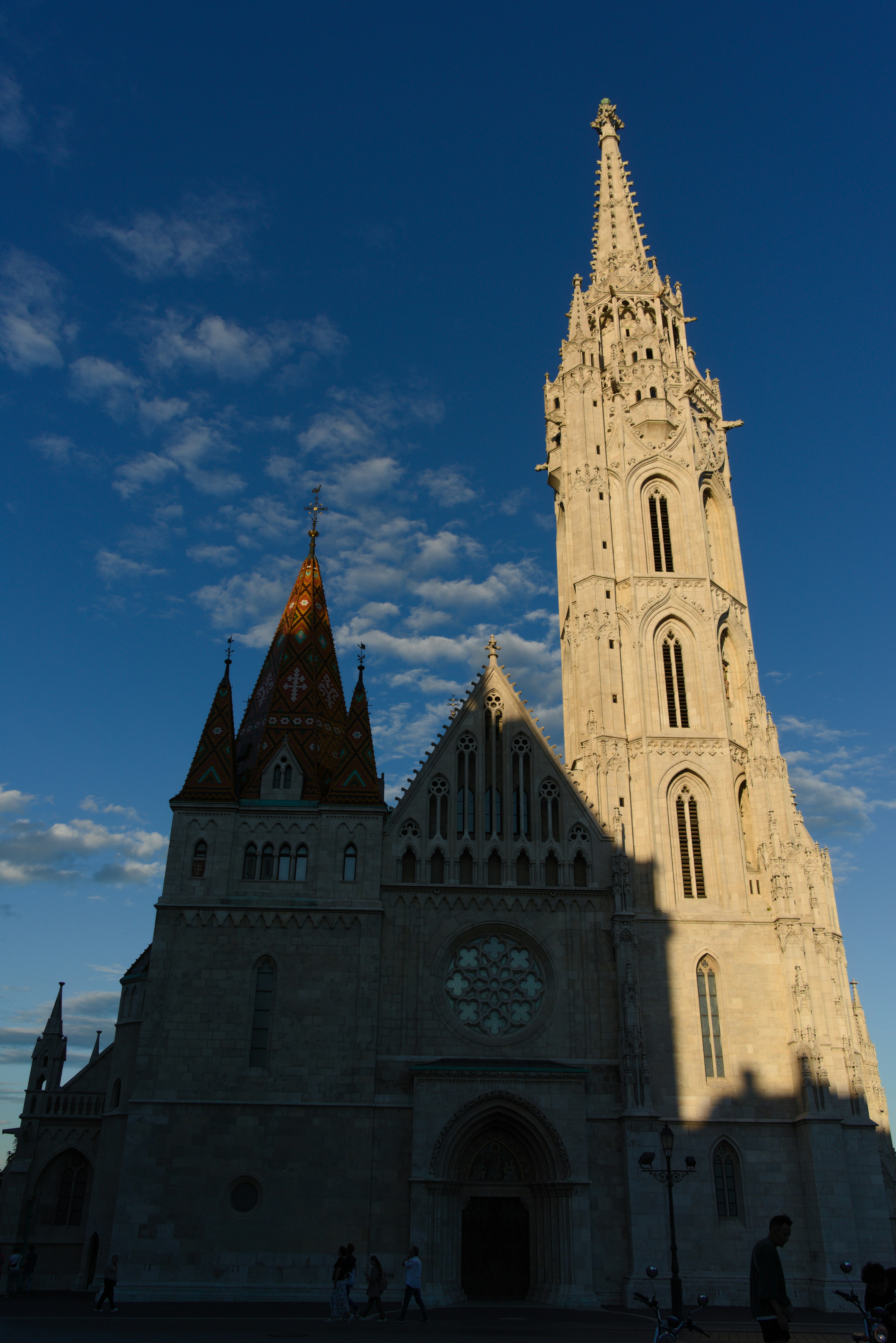 Historic church with tall steeple under a blue sky.
