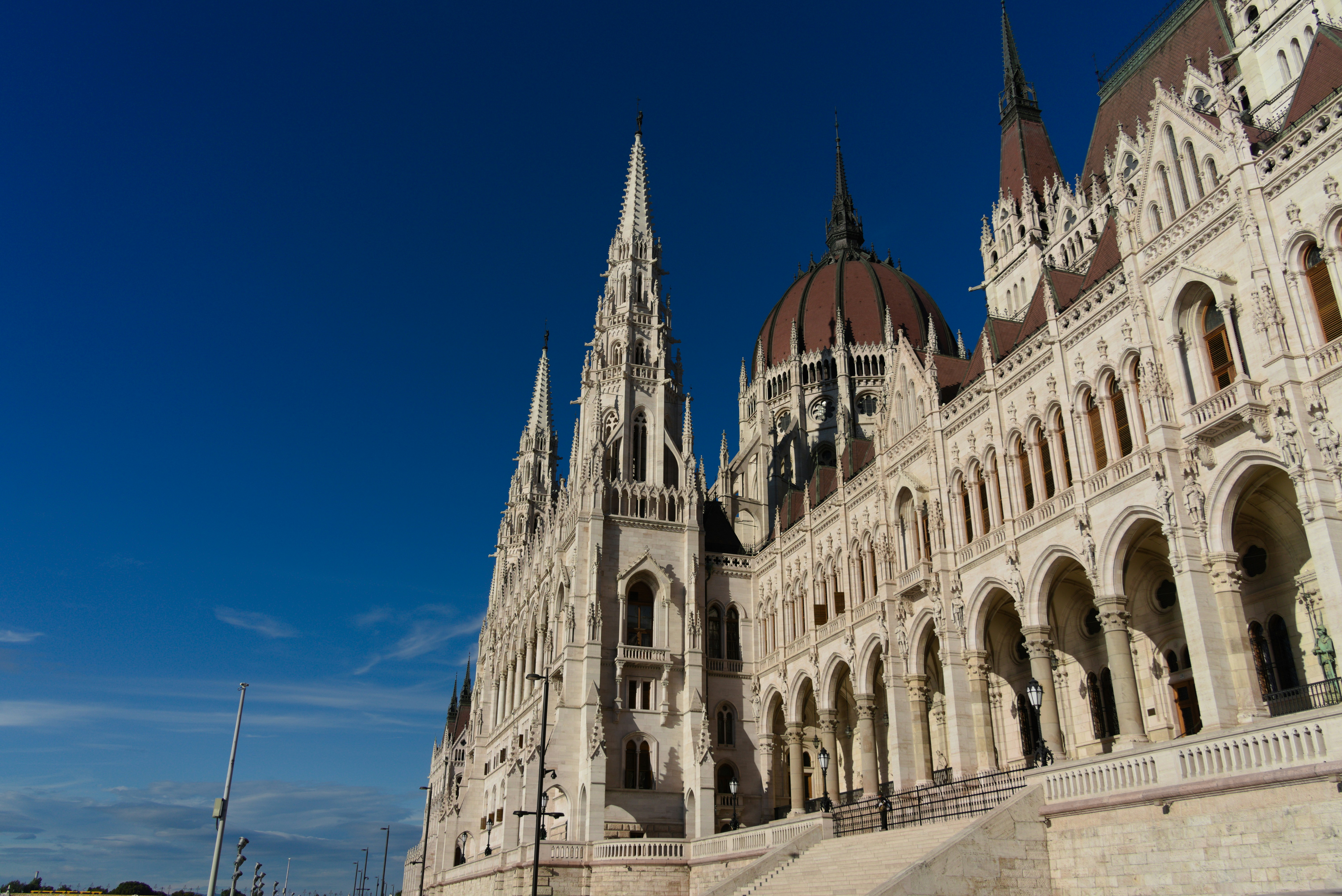 Ornate hungarian parliament building under a clear blue sky.