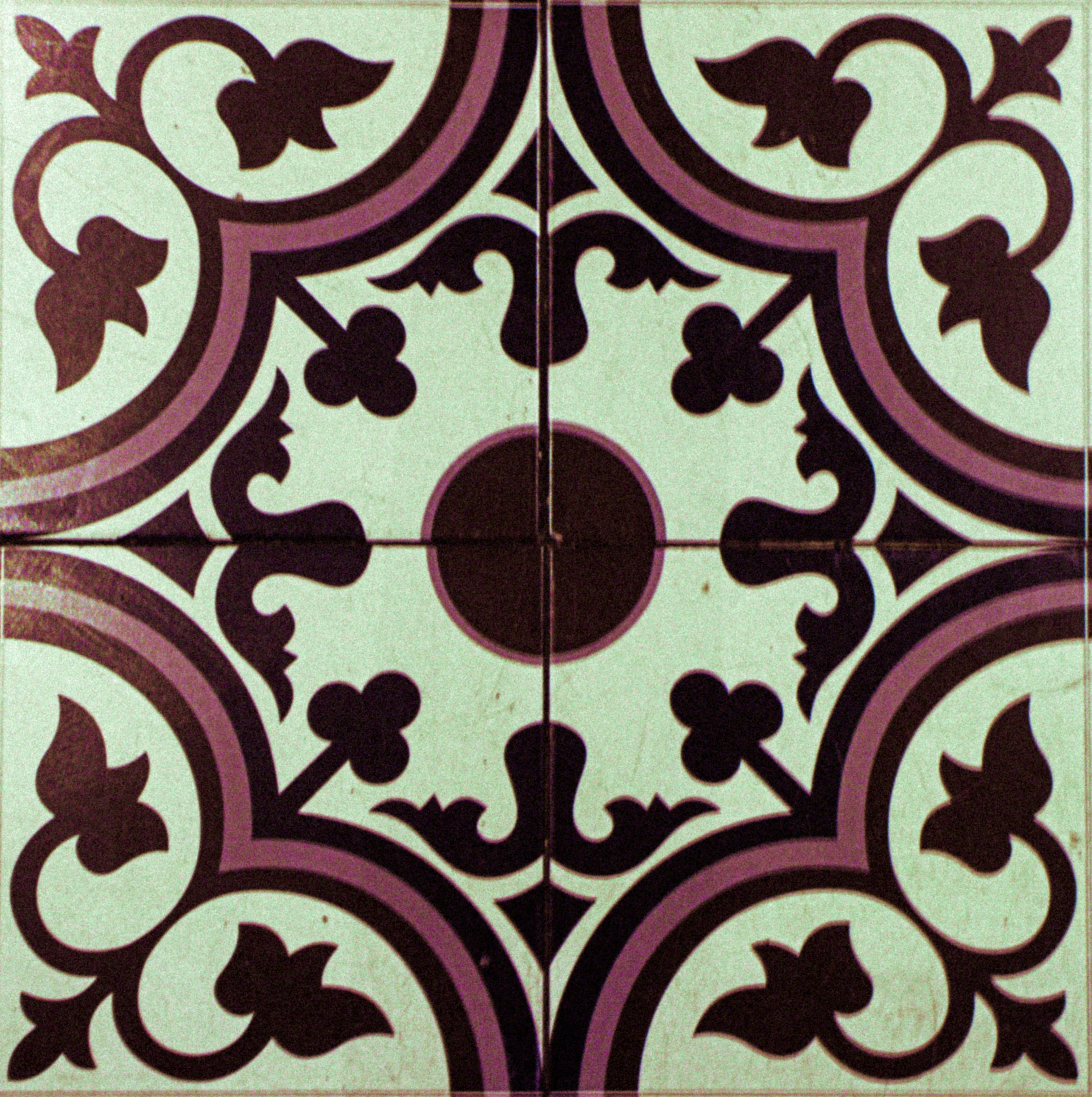 Intricate purple and white geometric tile pattern.
