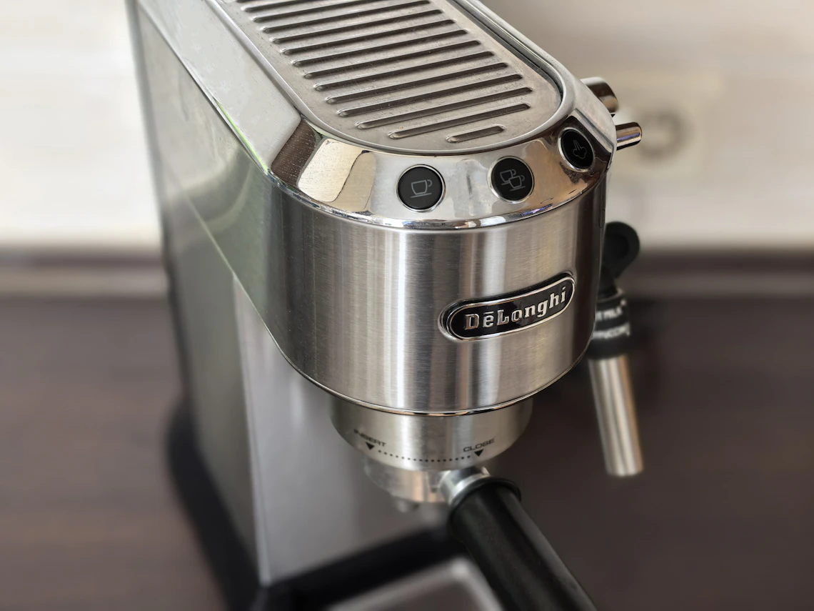 Real stainless steel coffee appliance shown in a refined kitchen setting