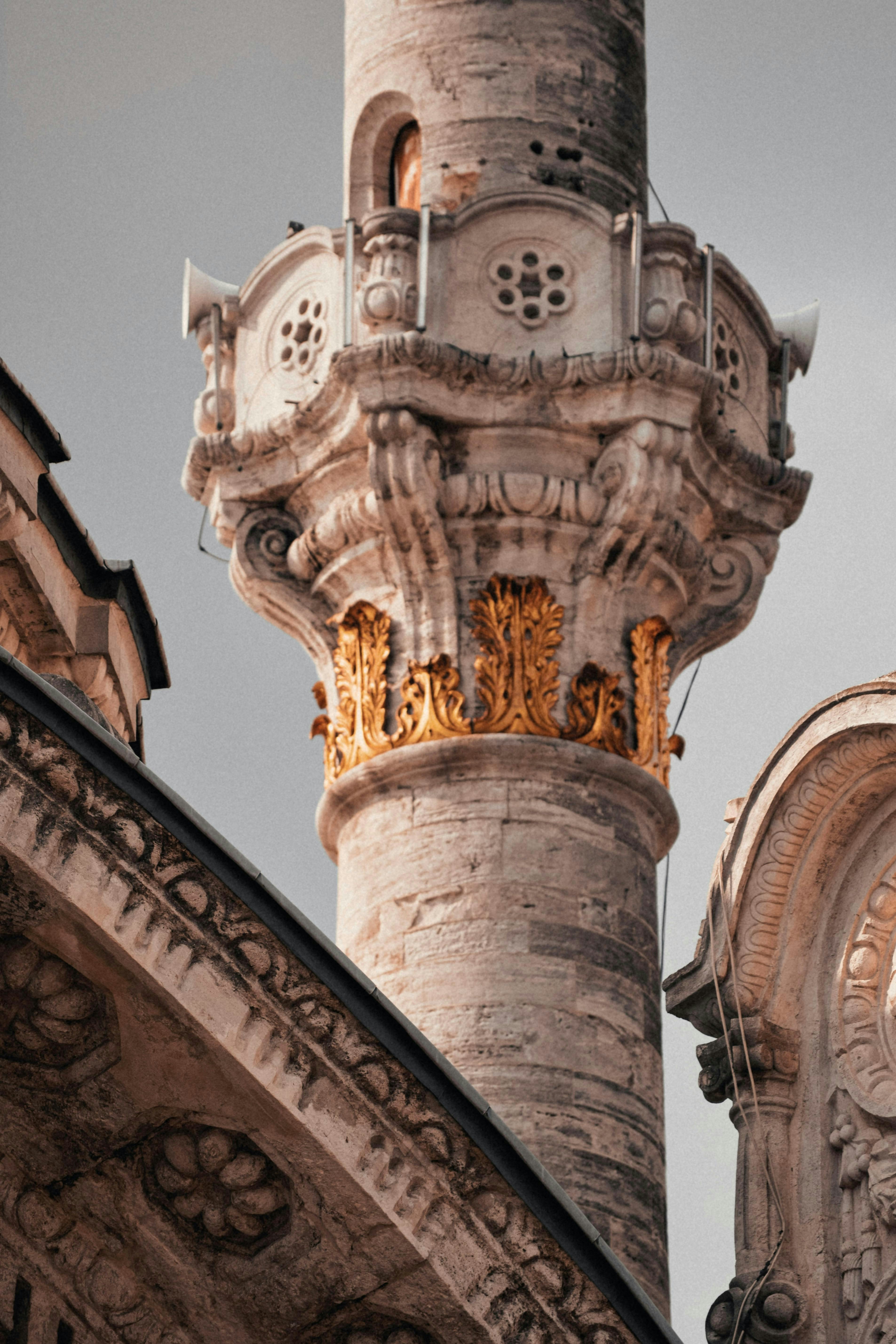 Intricate mosque minaret with golden decorations