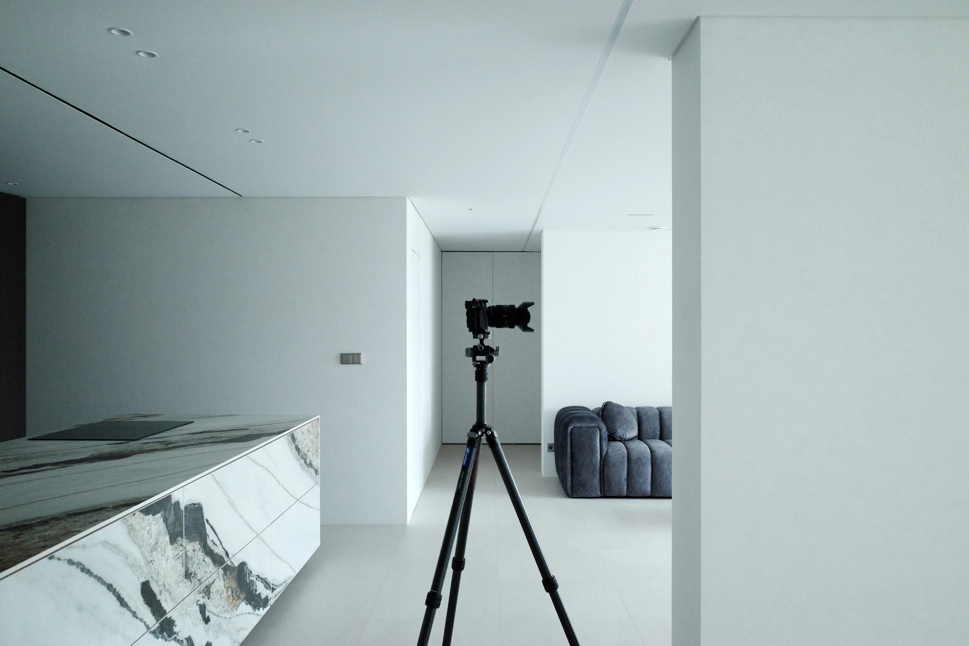 A camera on a tripod in a modern minimalist room.