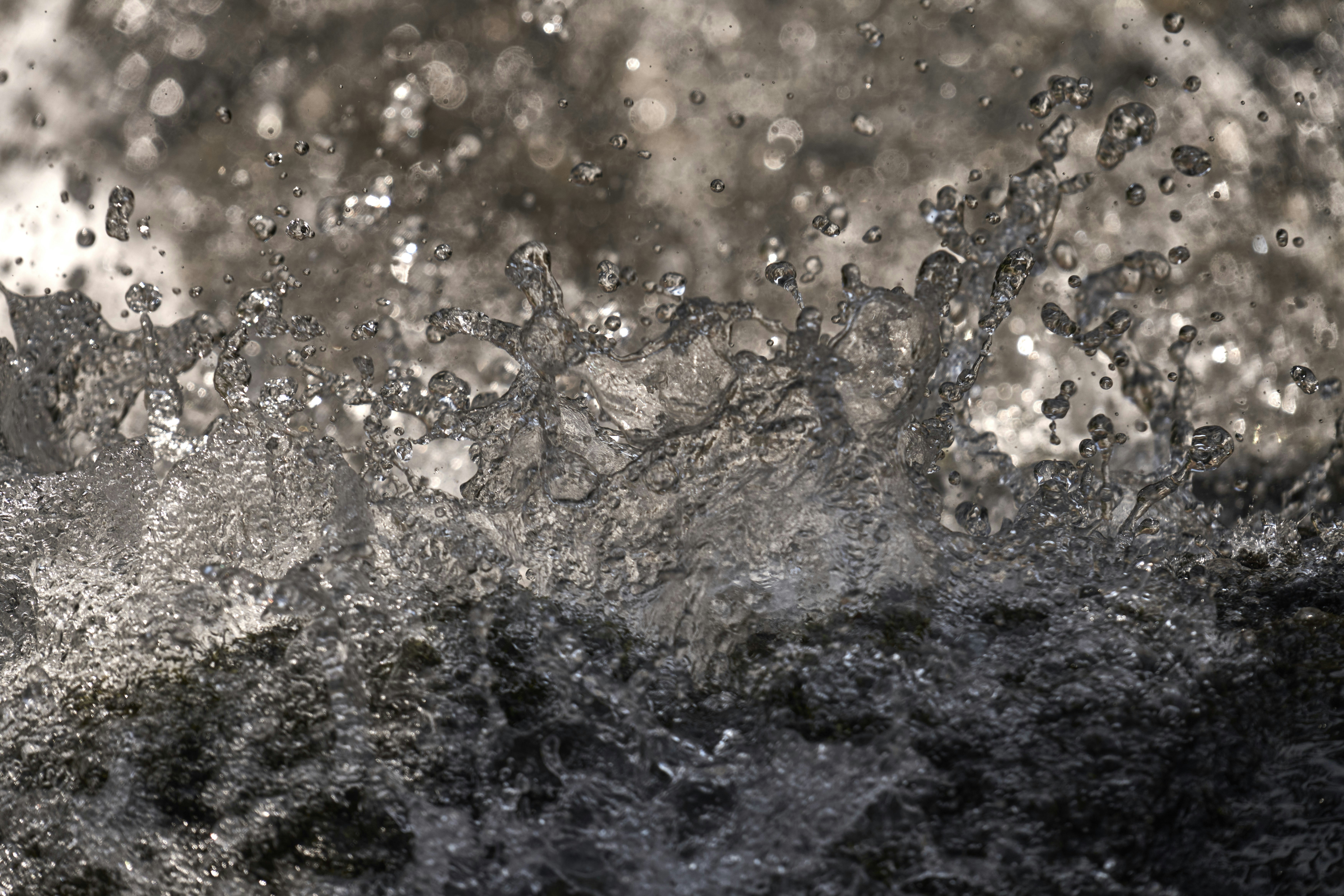 Water splashes and droplets create a dynamic, abstract pattern.