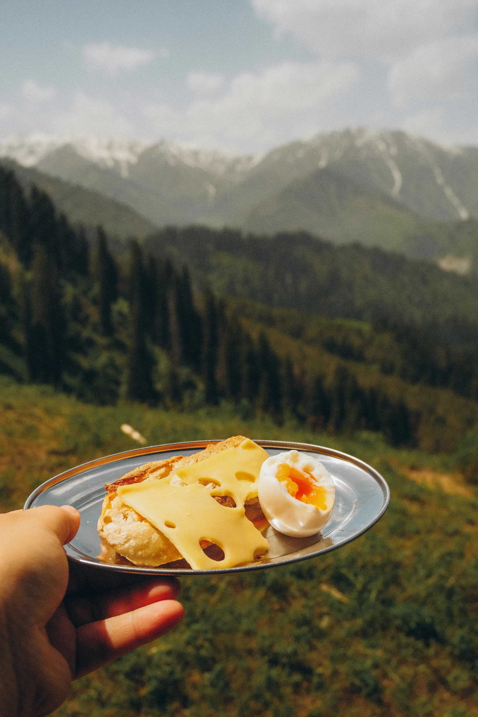 Breakfast plate held against the peaks