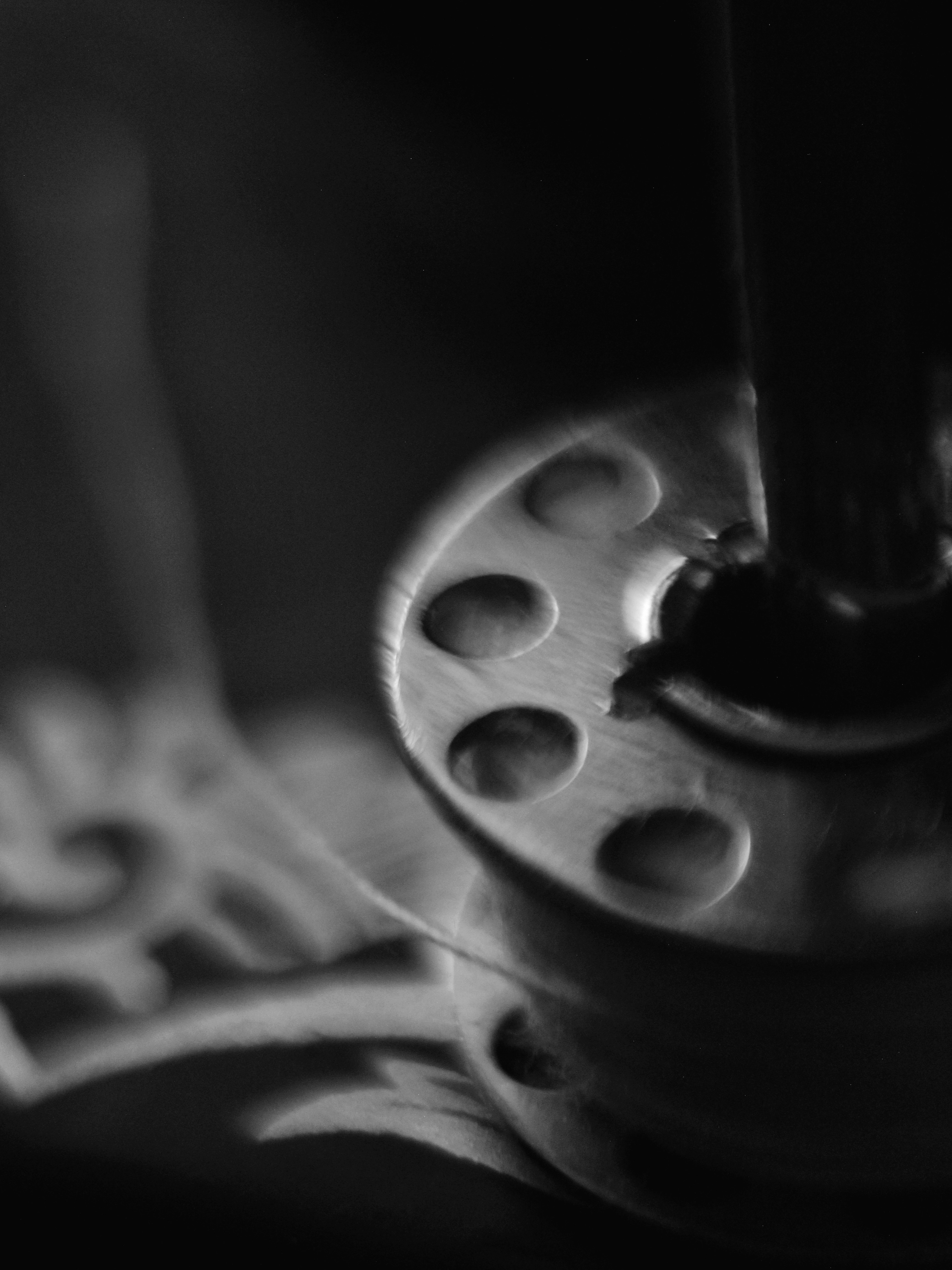 Sewing machine bobbin with thread, black and white.