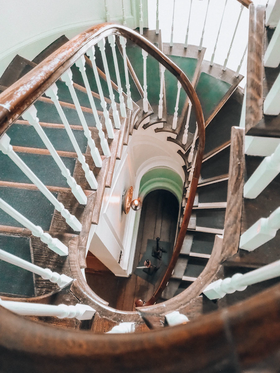 A comfortable armchair-style seat beside a sunlit home staircase