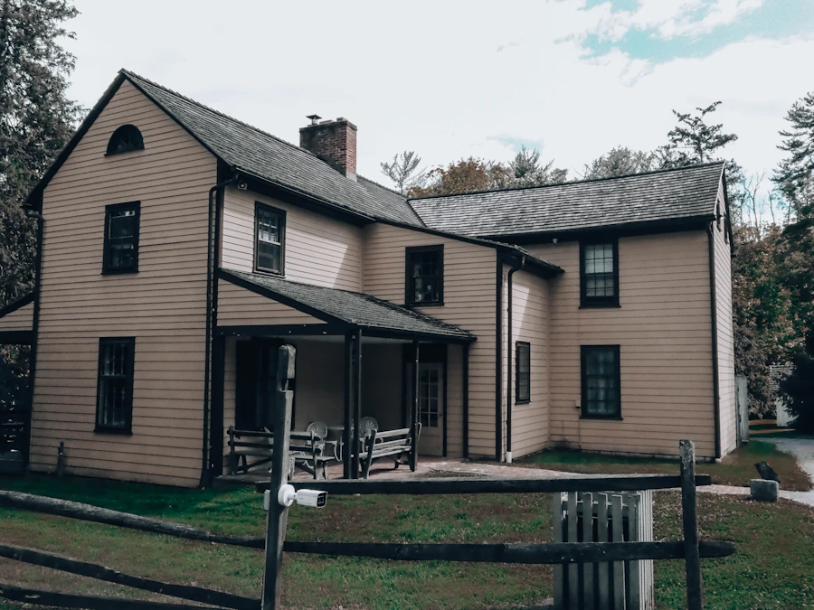 A tan two-story house with dark trim