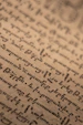 Old handwritten script on aged paper background.