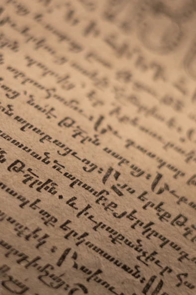 Old handwritten script on aged paper background.