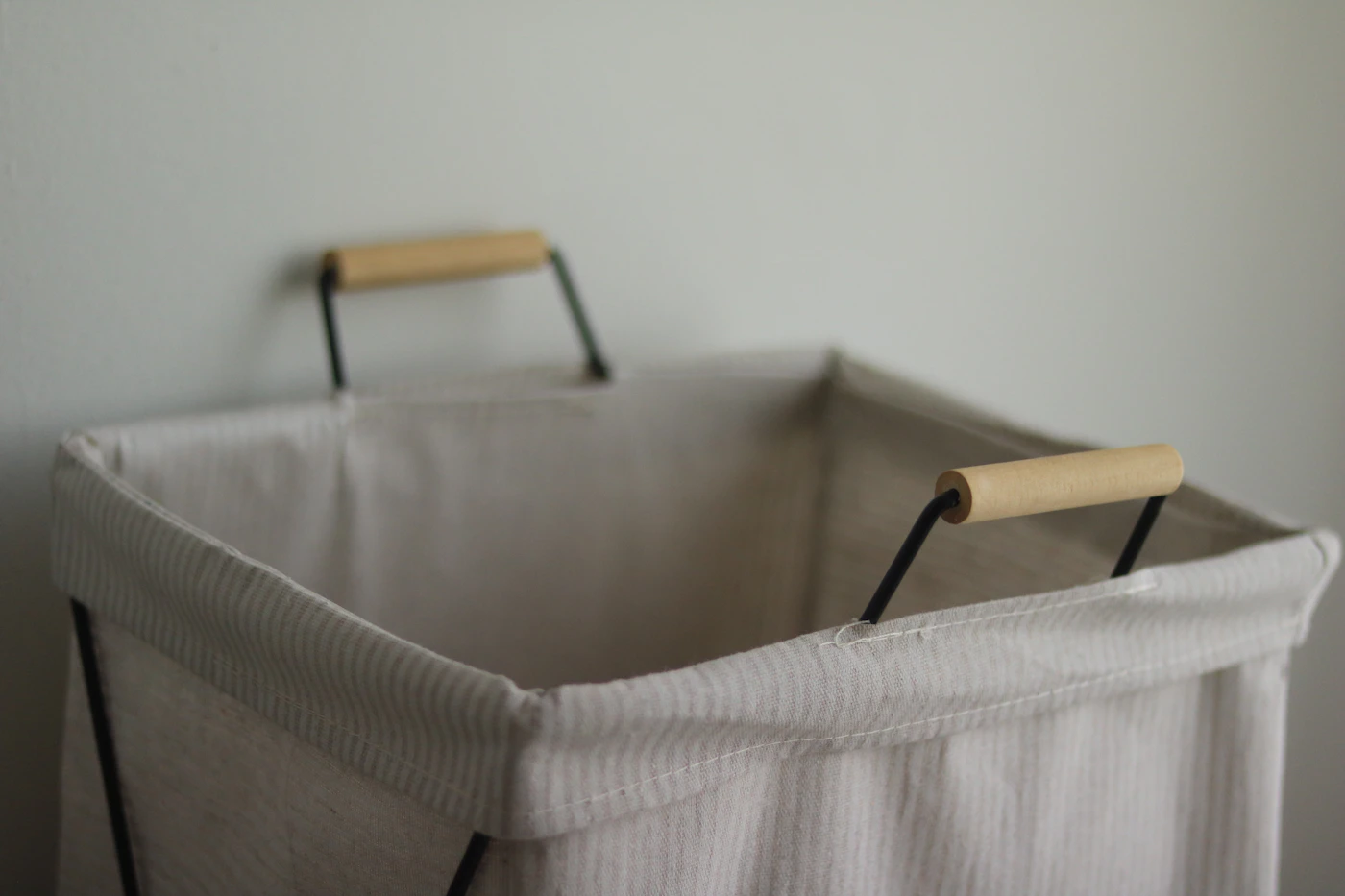 Light fabric laundry hamper with wooden handles