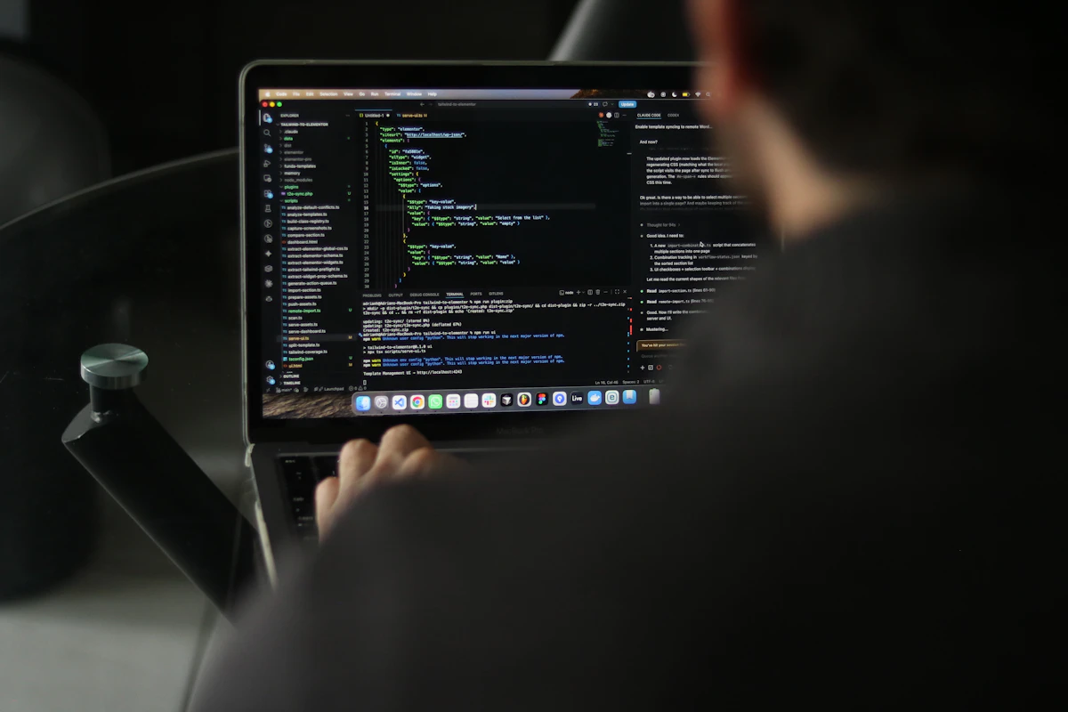 Developer typing code on a laptop screen