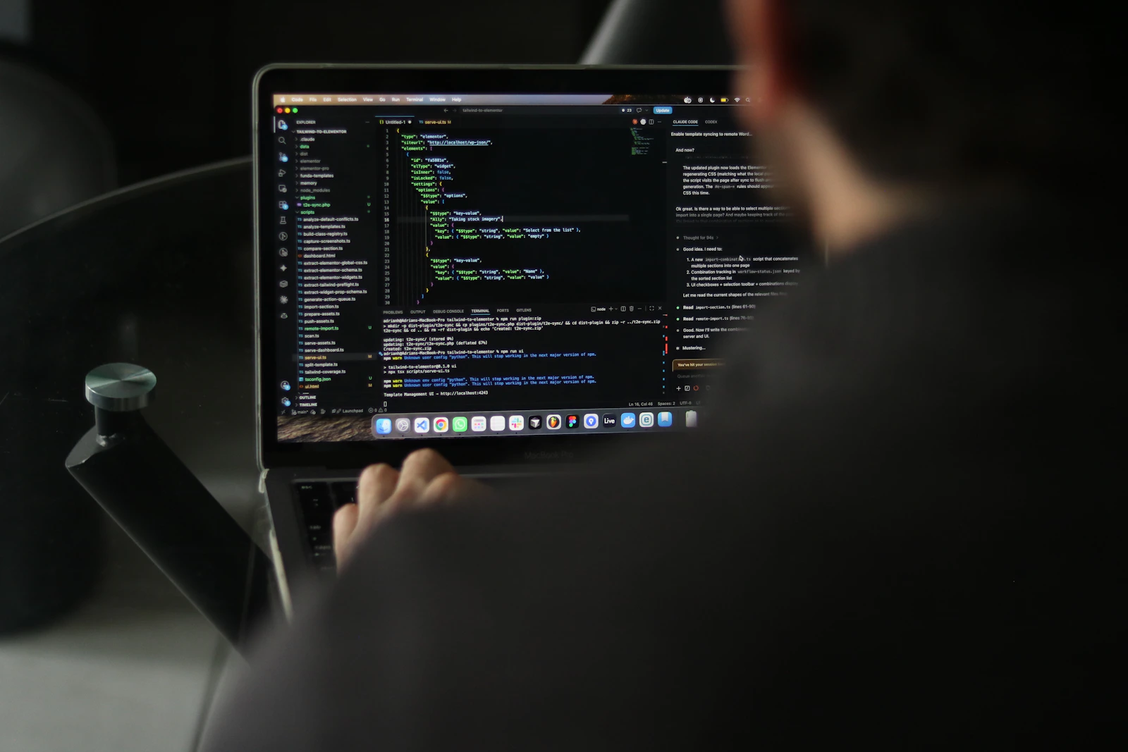 Developer workspace with laptop displaying source code