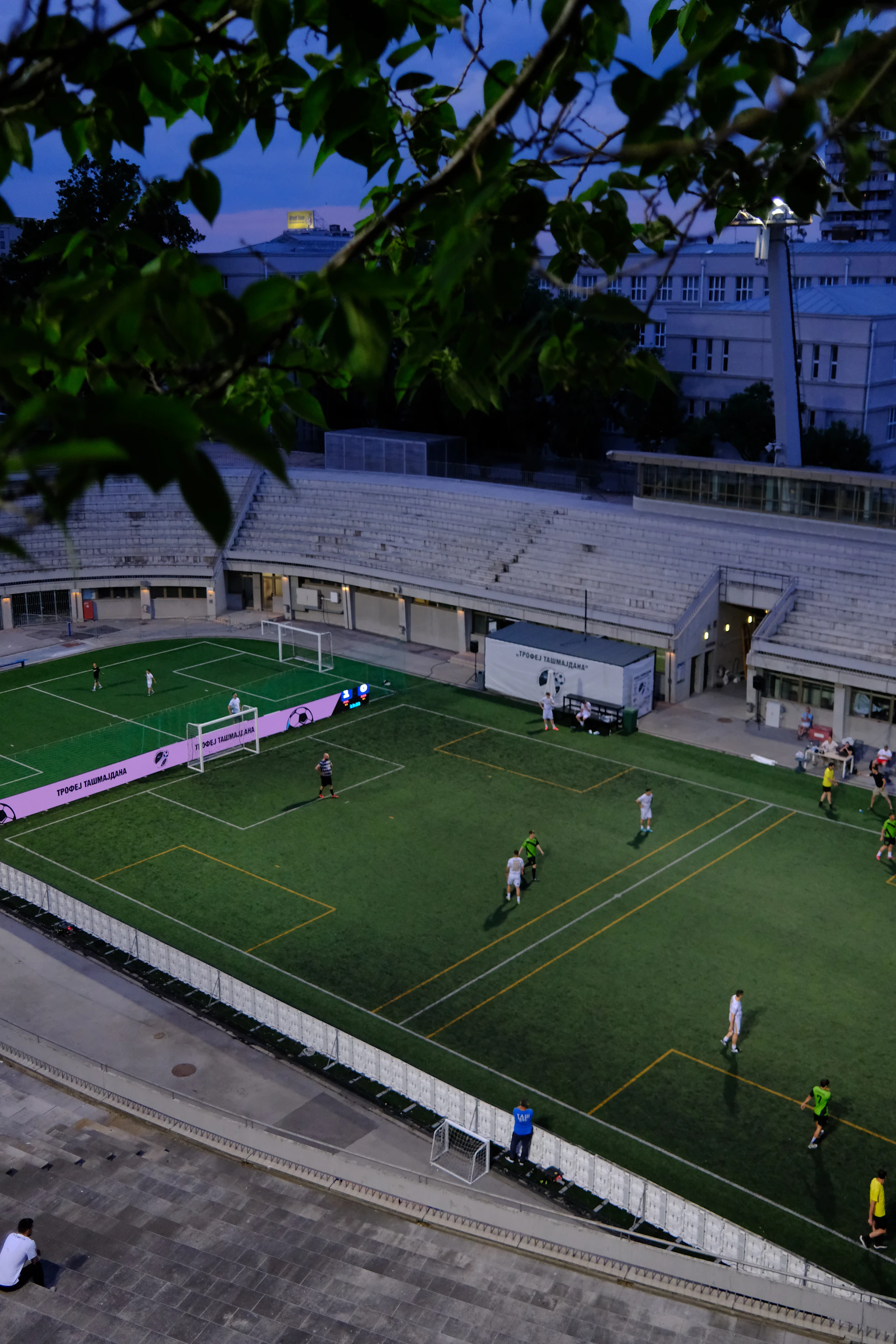 Football players on a field at dusk