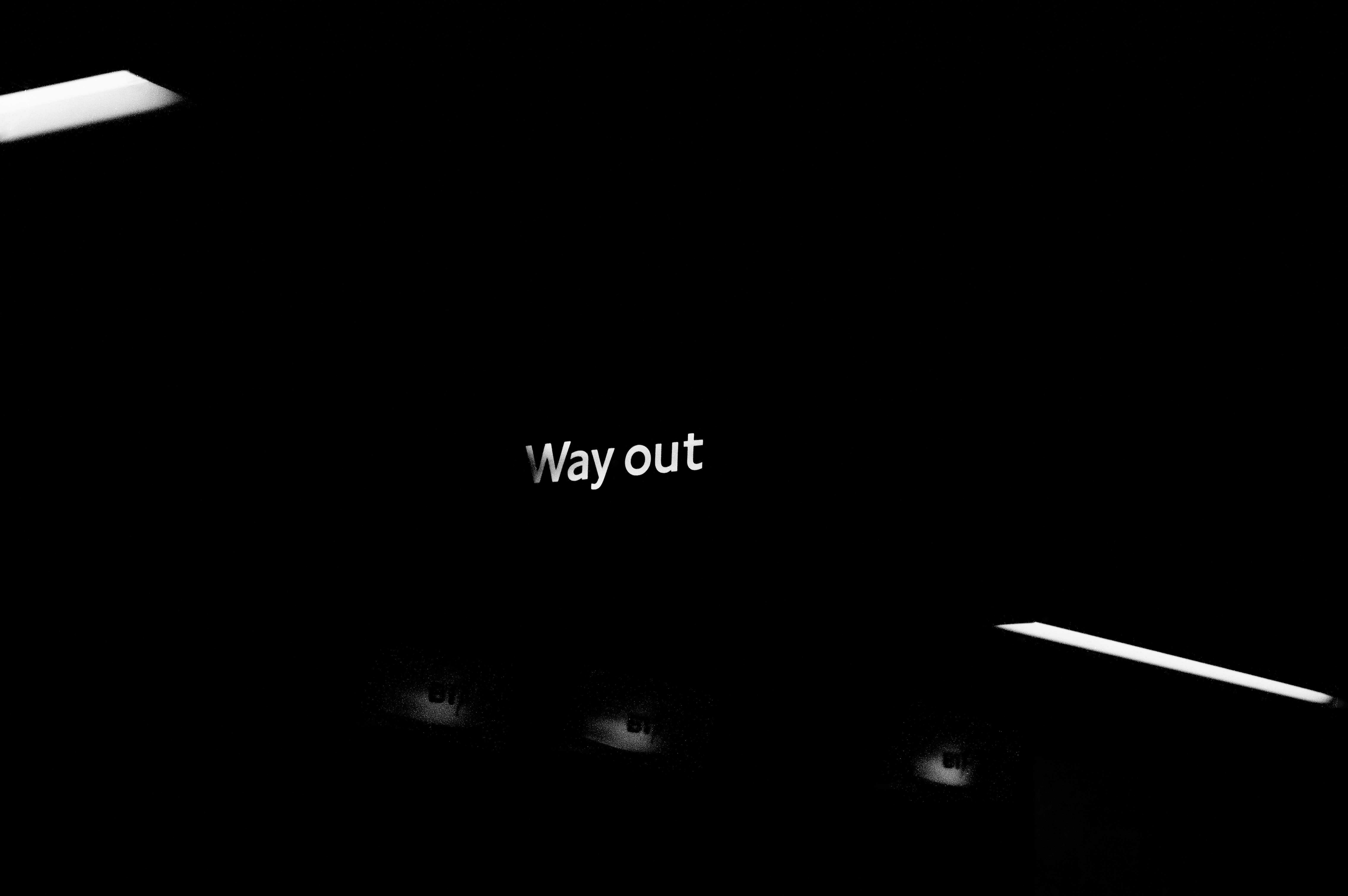 White 'way out' text on a dark background.