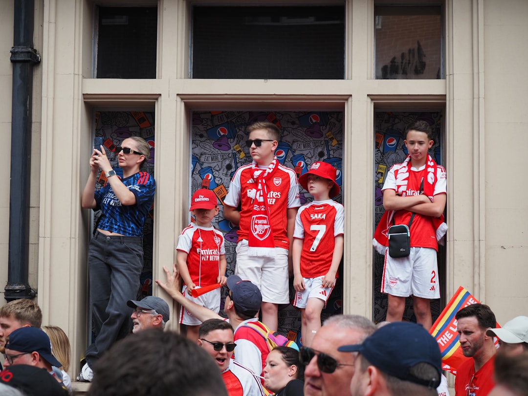 Arsenal fans watch from windows during a celebration.