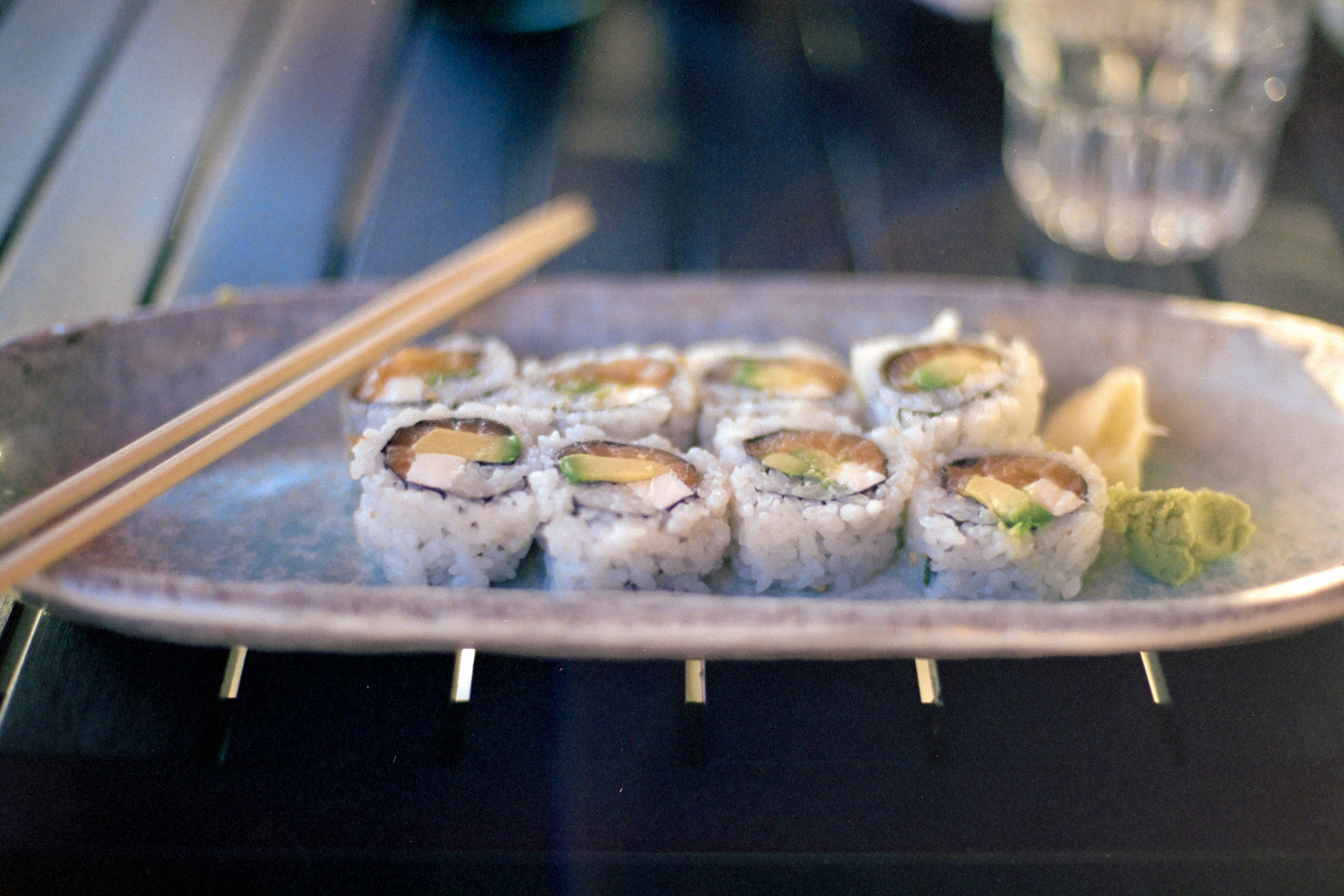 Sushi rolls on a plate with chopsticks