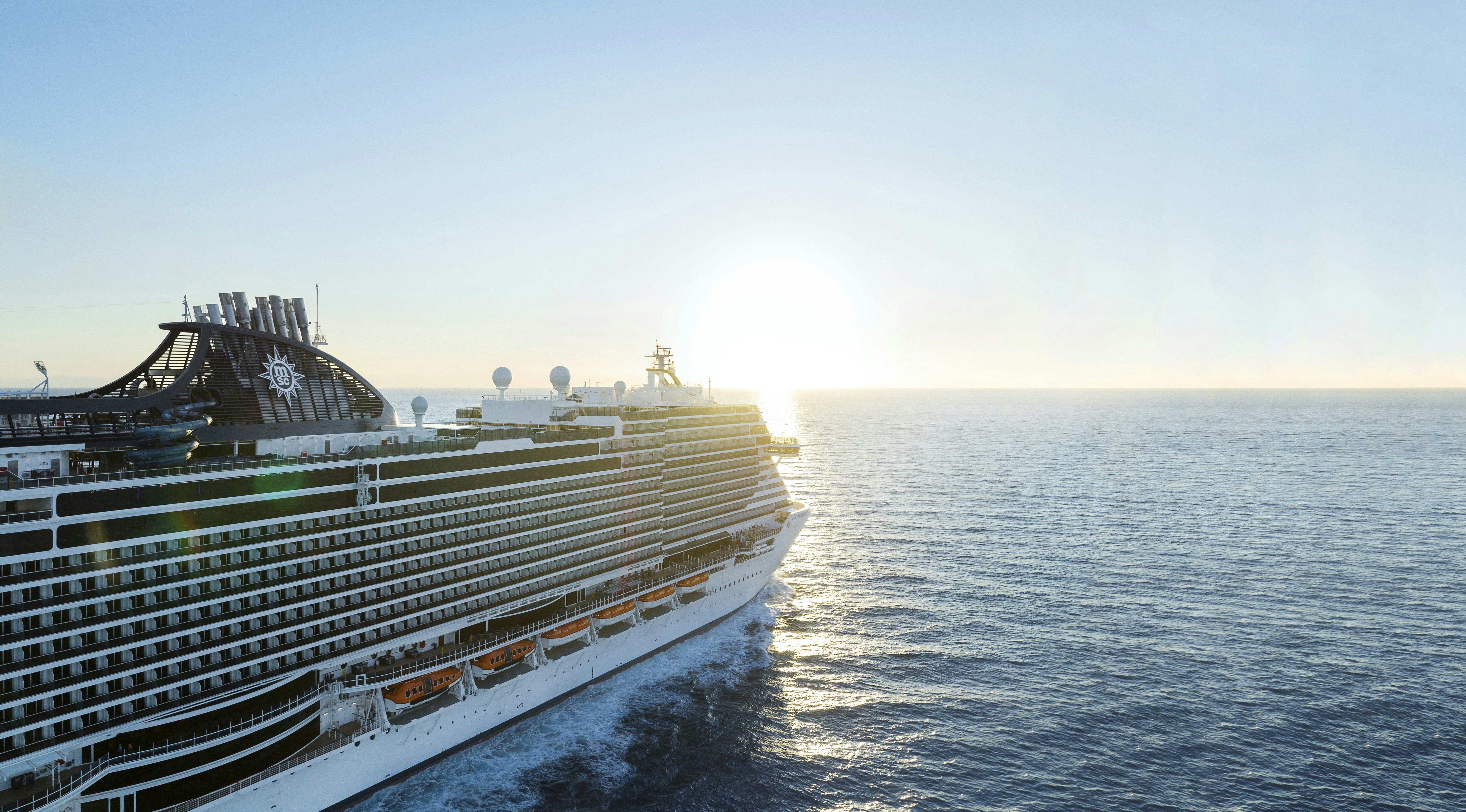 Large cruise ship sailing at sunset