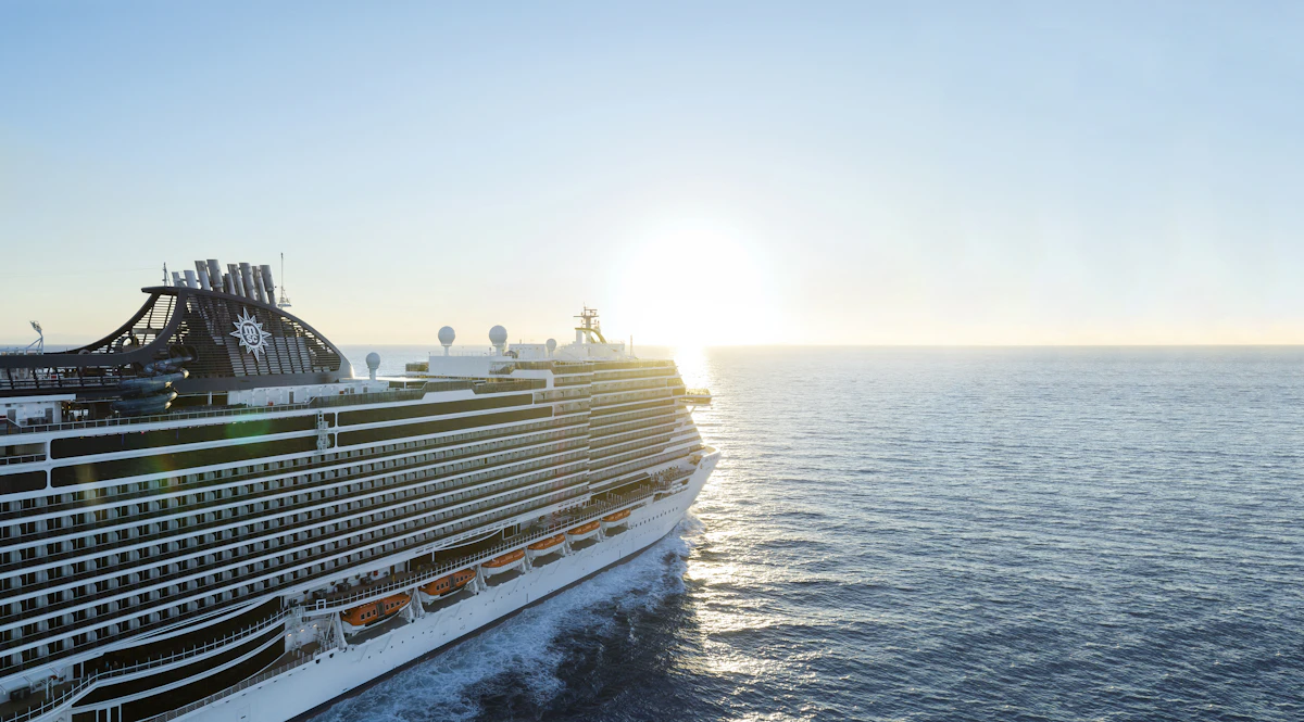 Large cruise ship sailing on the ocean at sunset