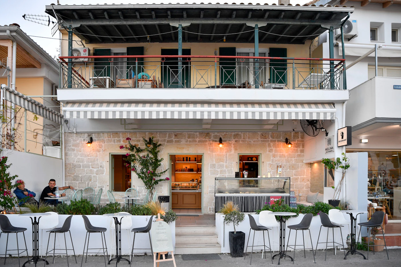 A welcoming stone café terrace in the evening