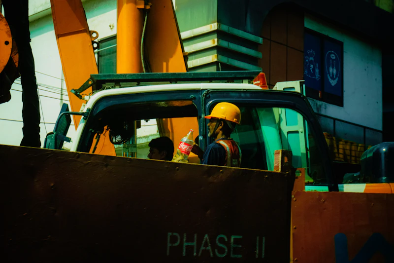 Construction worker in hard hat operating heavy machinery
