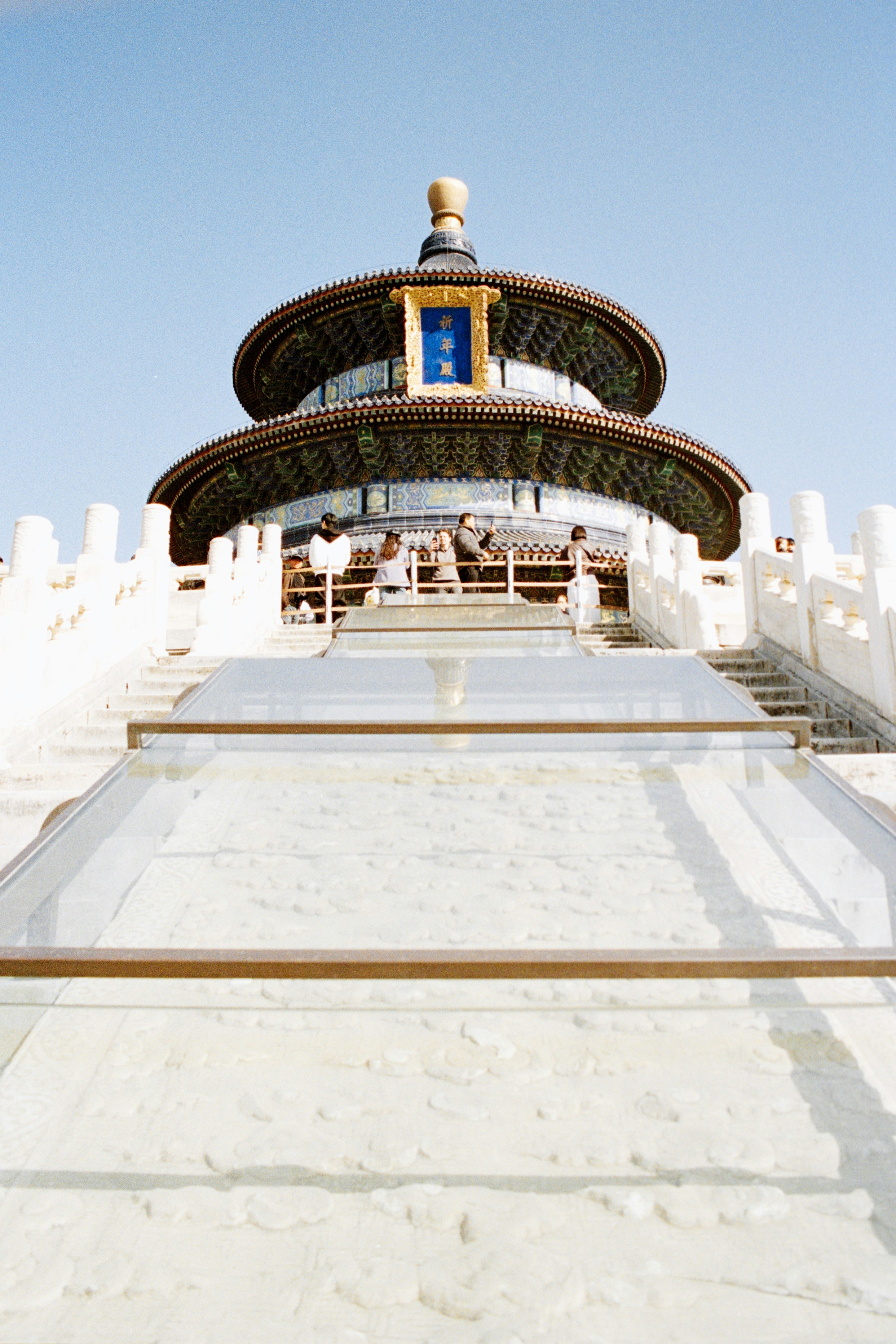 Ornate tiered chinese temple with white stone steps.
