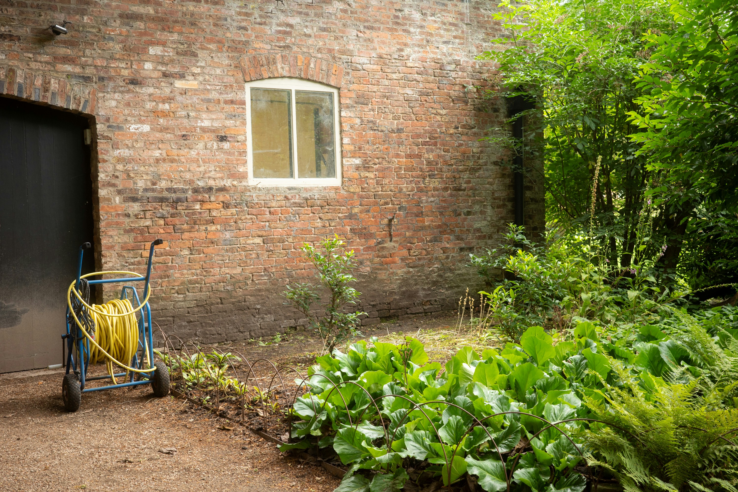 Professional pressure washing technician cleaning a home exterior