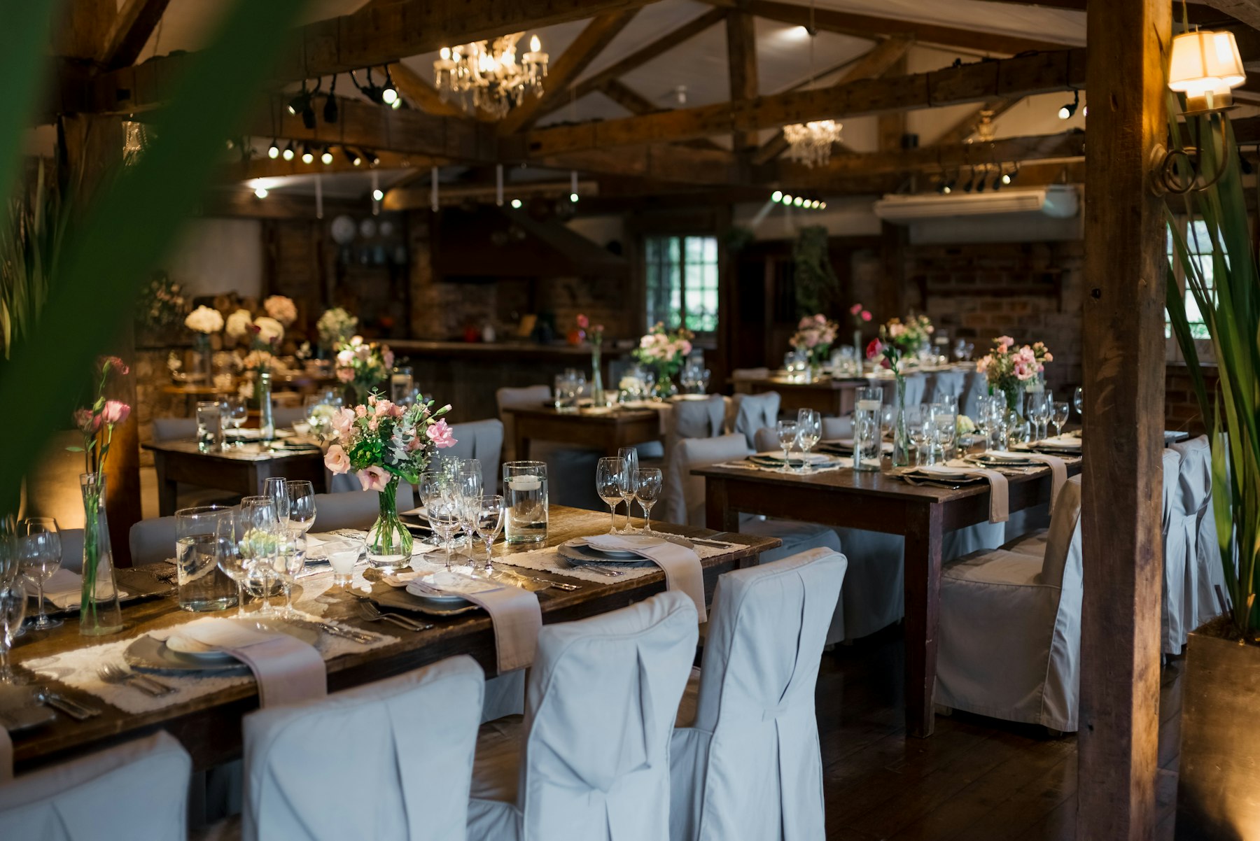Elegant barn wedding reception with warm lighting and floral decor