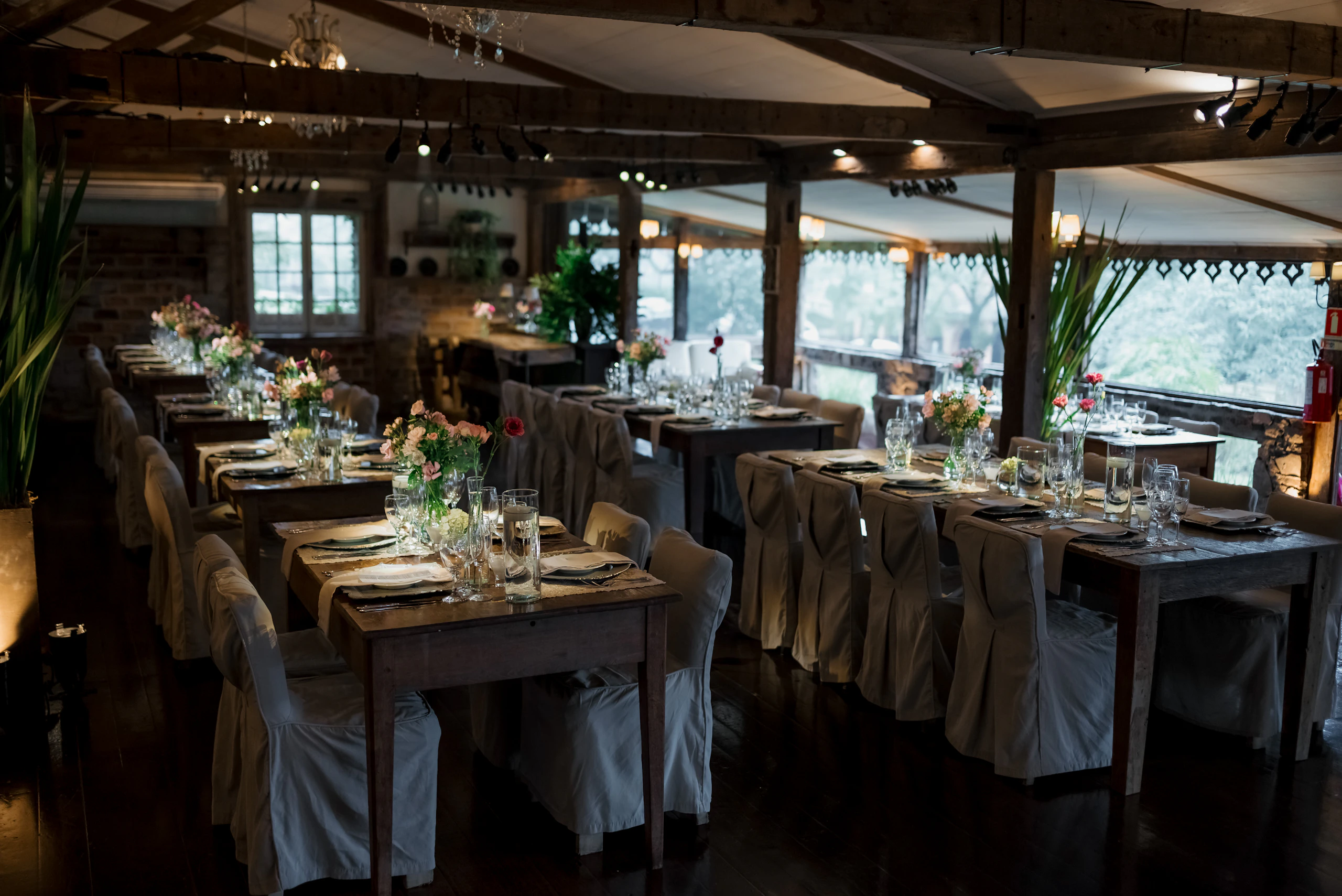 Long reception tables set inside a barn
