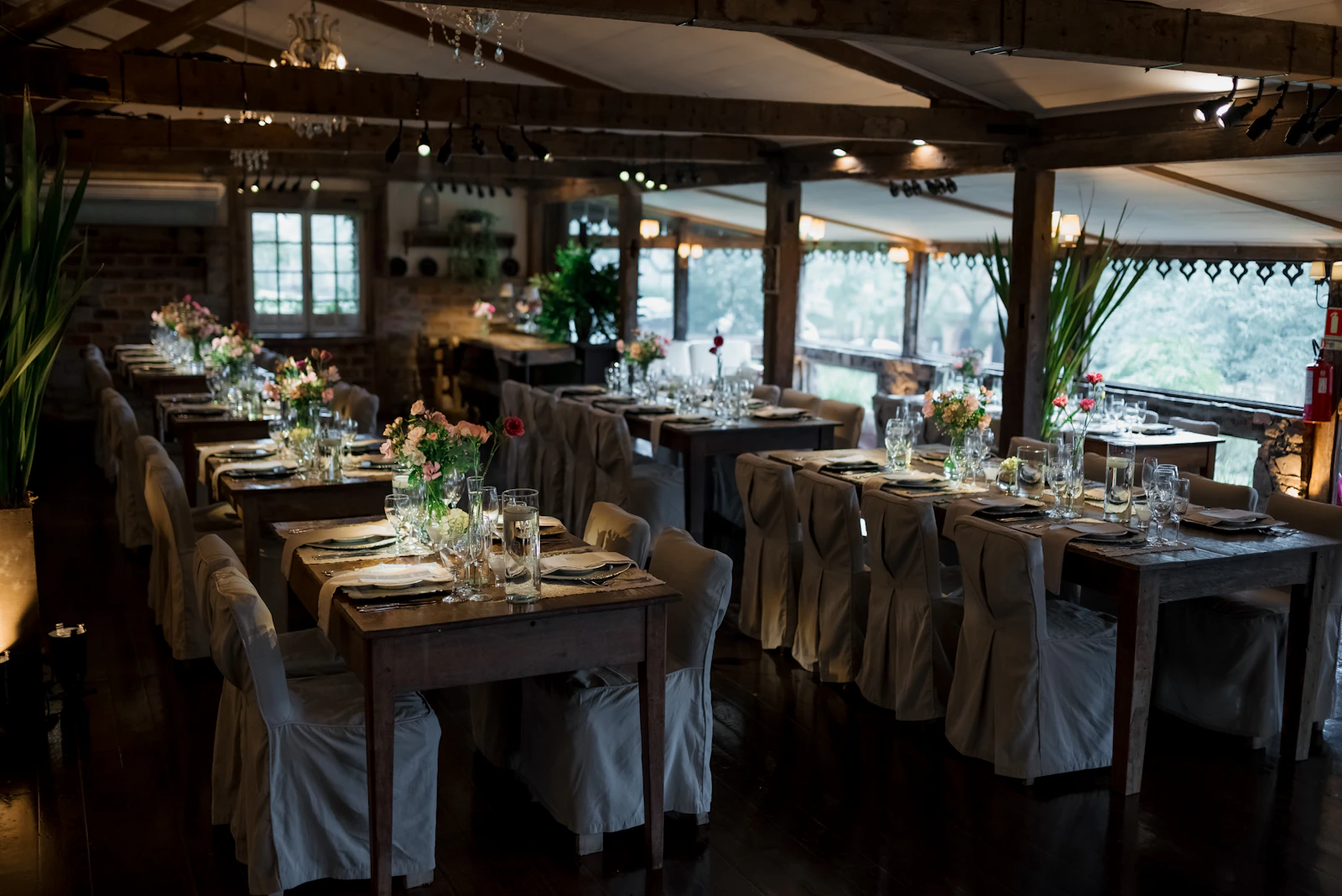 Dim elegant dining room with set tables