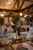 Elegant table setting with pink flowers in a rustic venue