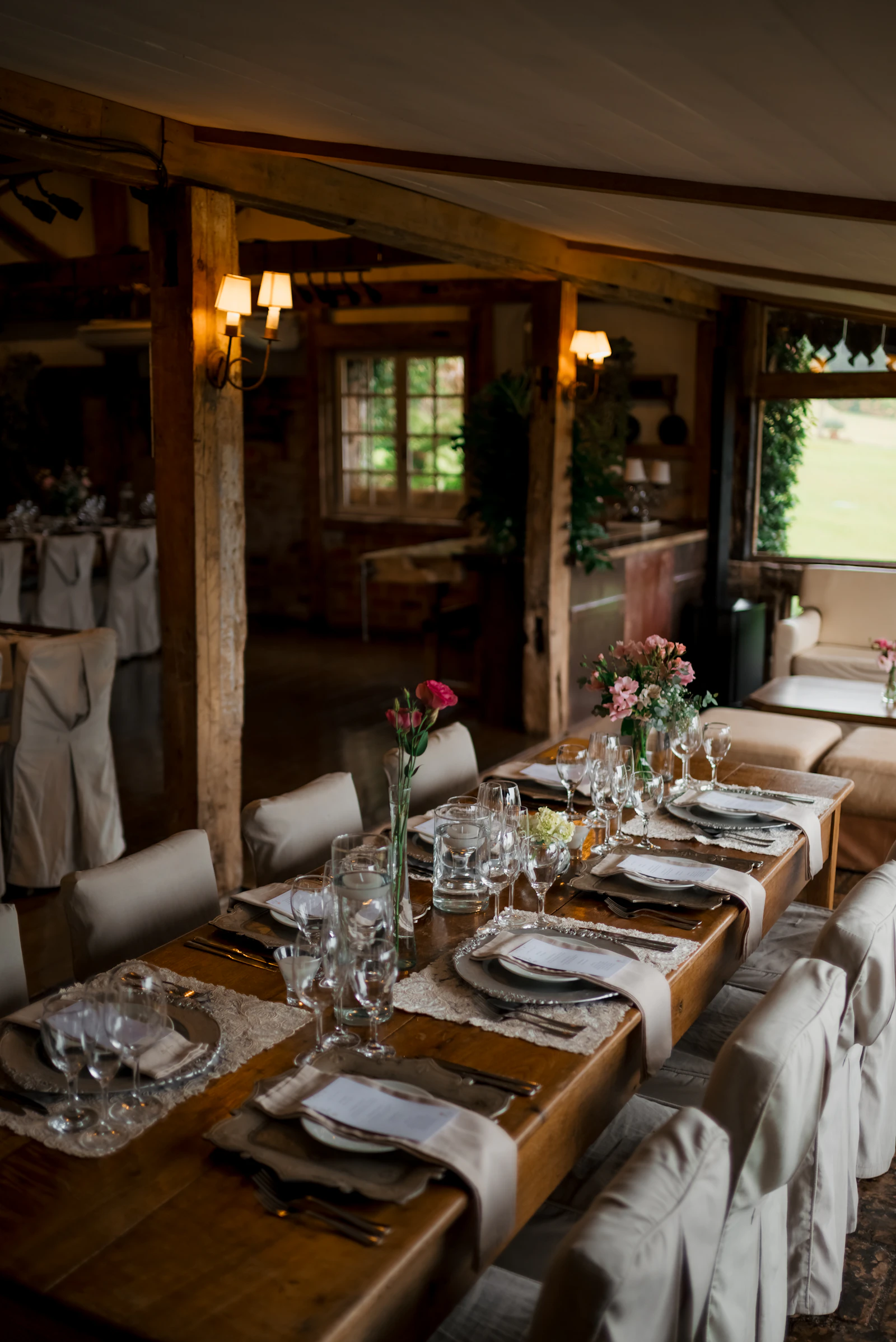 A rustic wedding table laid with candles and flowers before the guests sit down