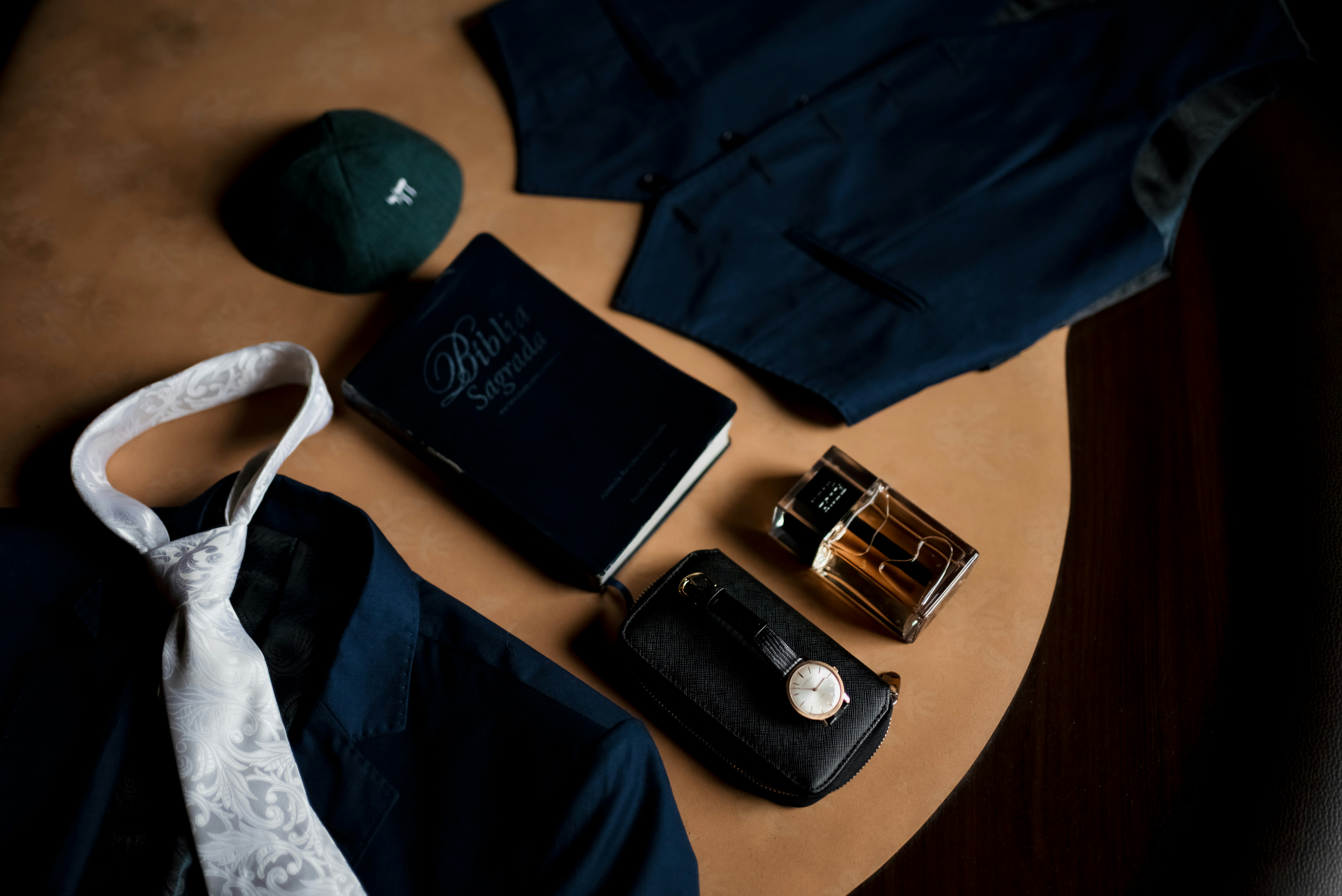 Men's formal attire and accessories laid out on a table.