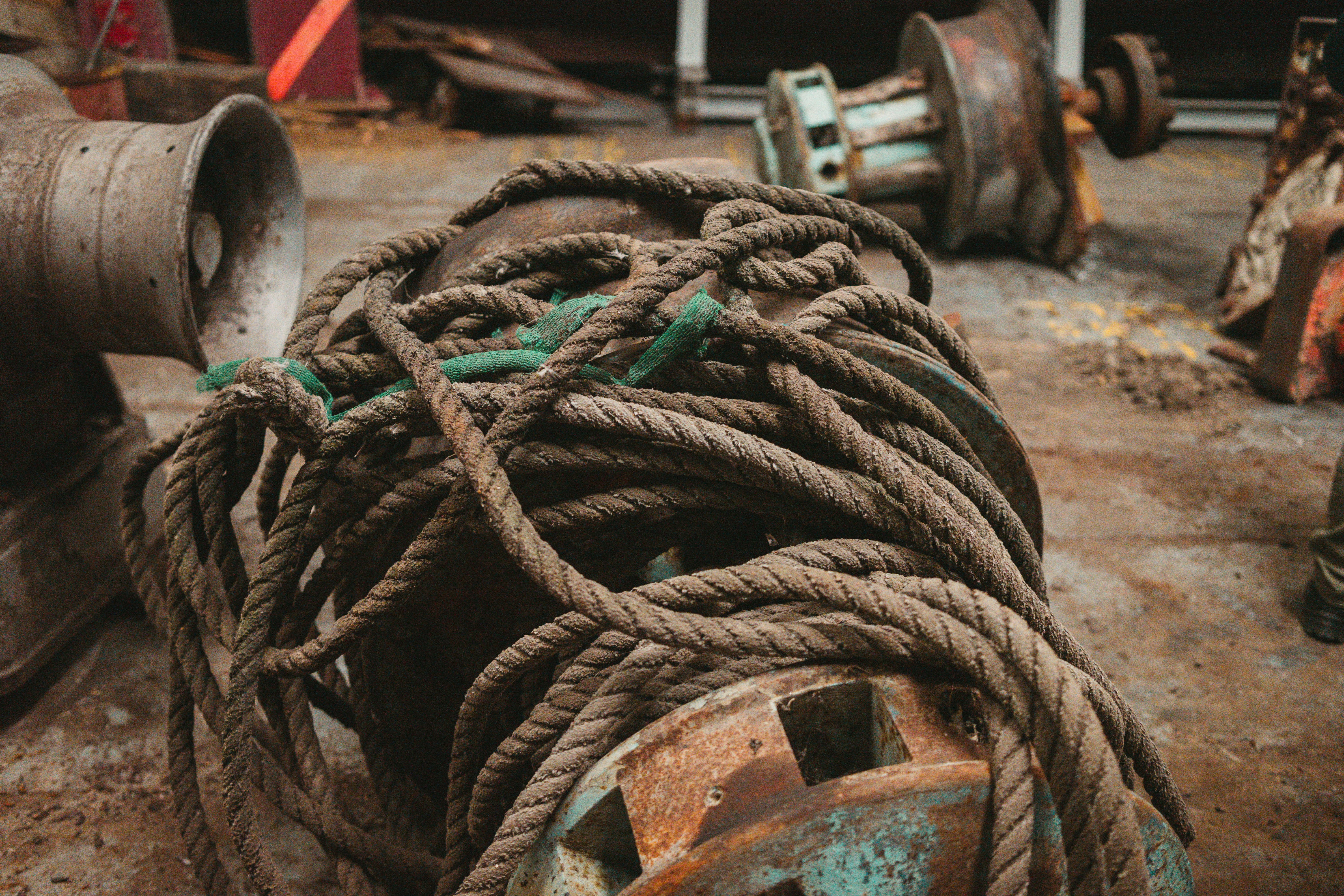 Old coiled rope on rusty industrial equipment