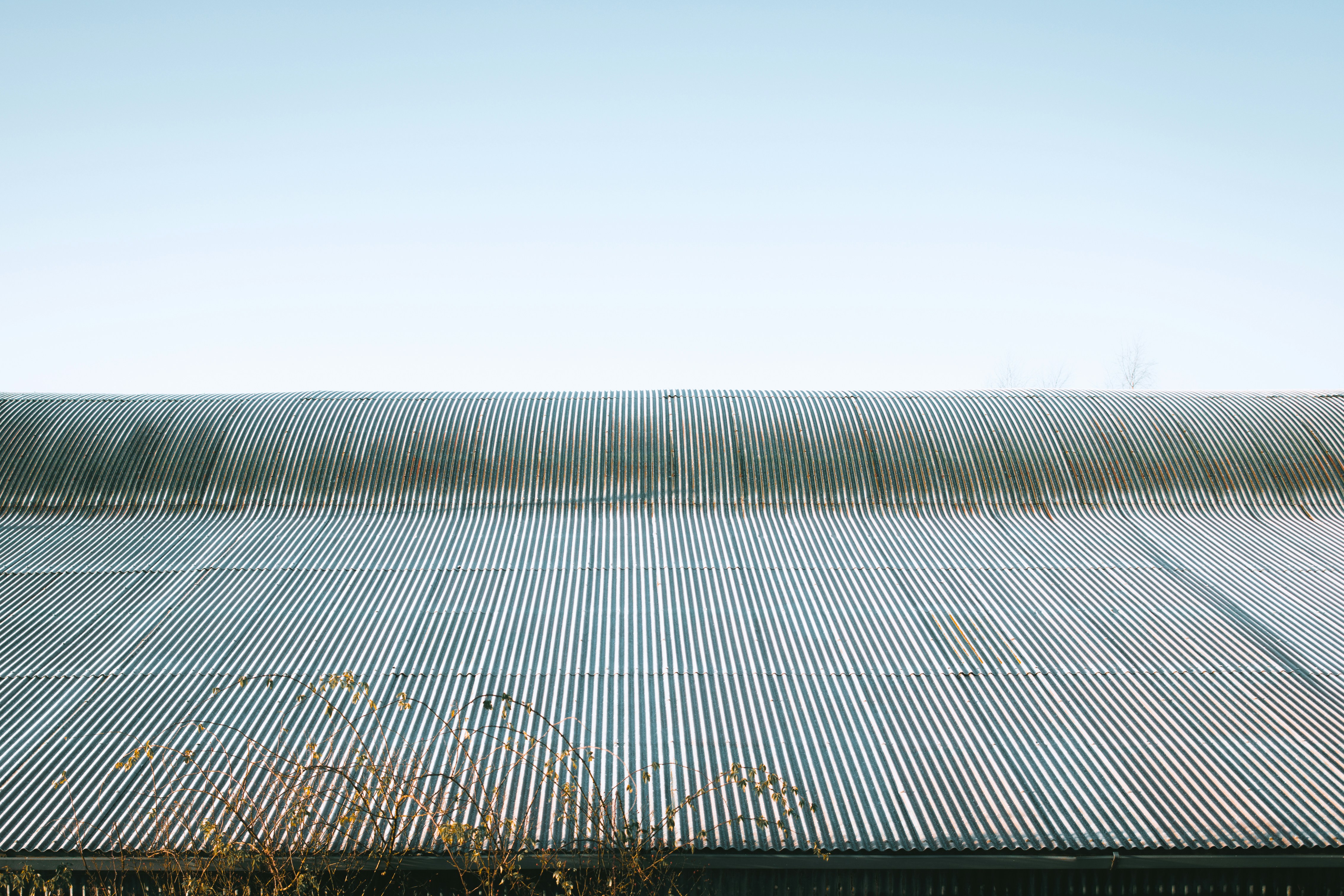 Corrugated metal roof reflecting bright sunlight on a sunny day