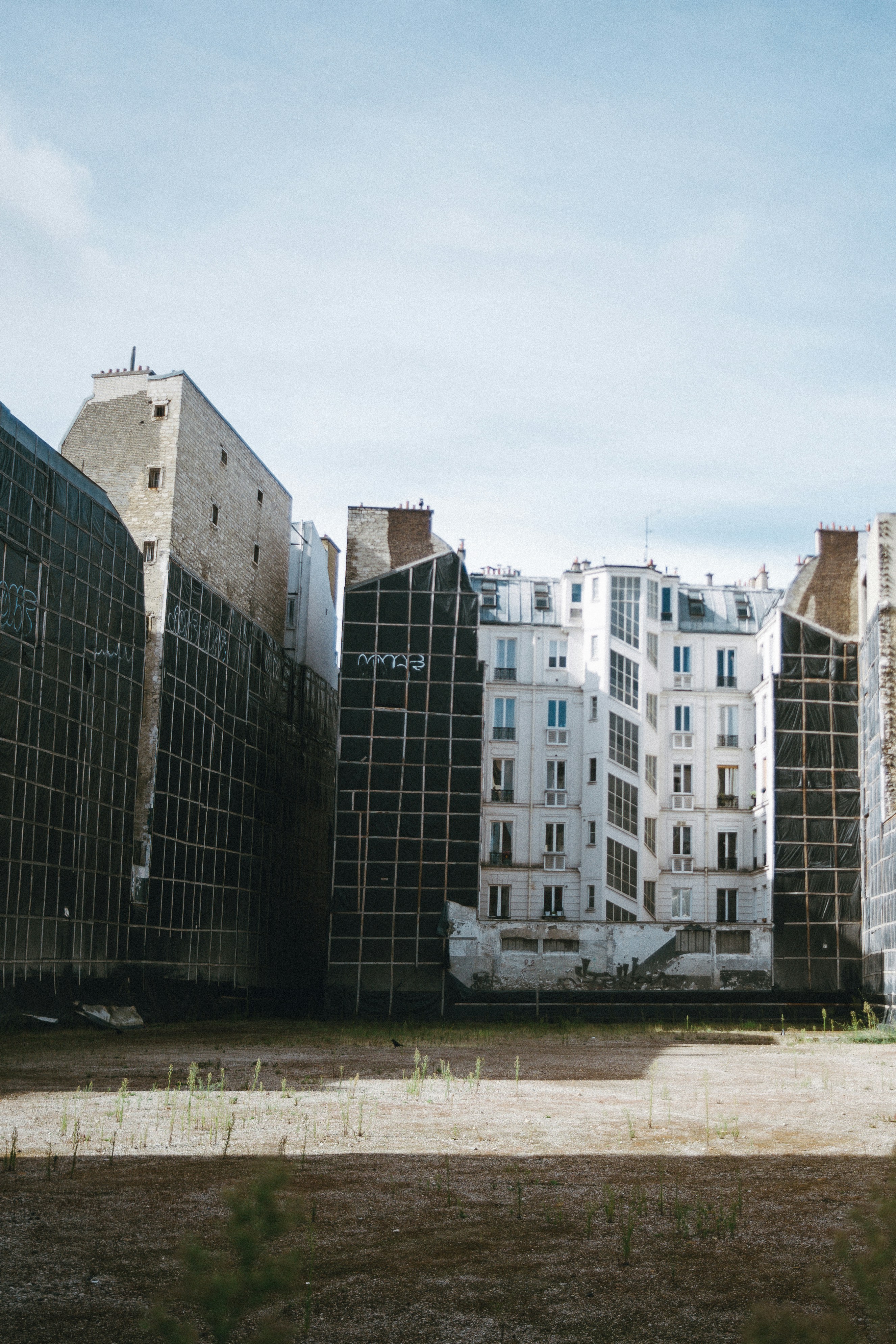 Empty urban lot surrounded by diverse architectural buildings