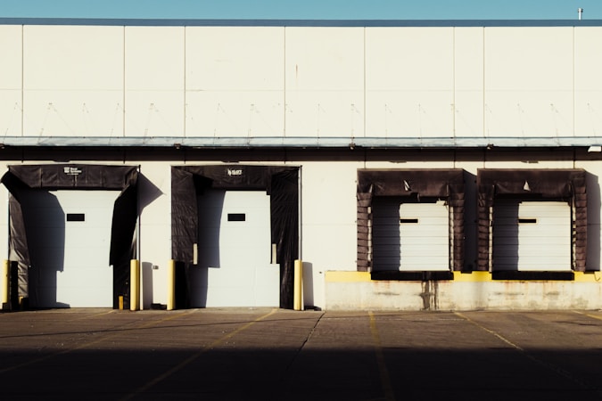 A row of dock-high loading doors on a commercial industrial building, the loading setup planned for Southwest Bay in Las Vegas