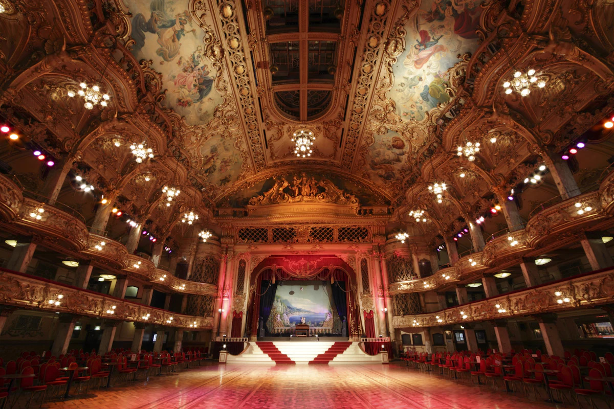 Tiered auditorium in red and gold. Illustrative editorial image, not a photograph of Alaska Heavenly Lodge.