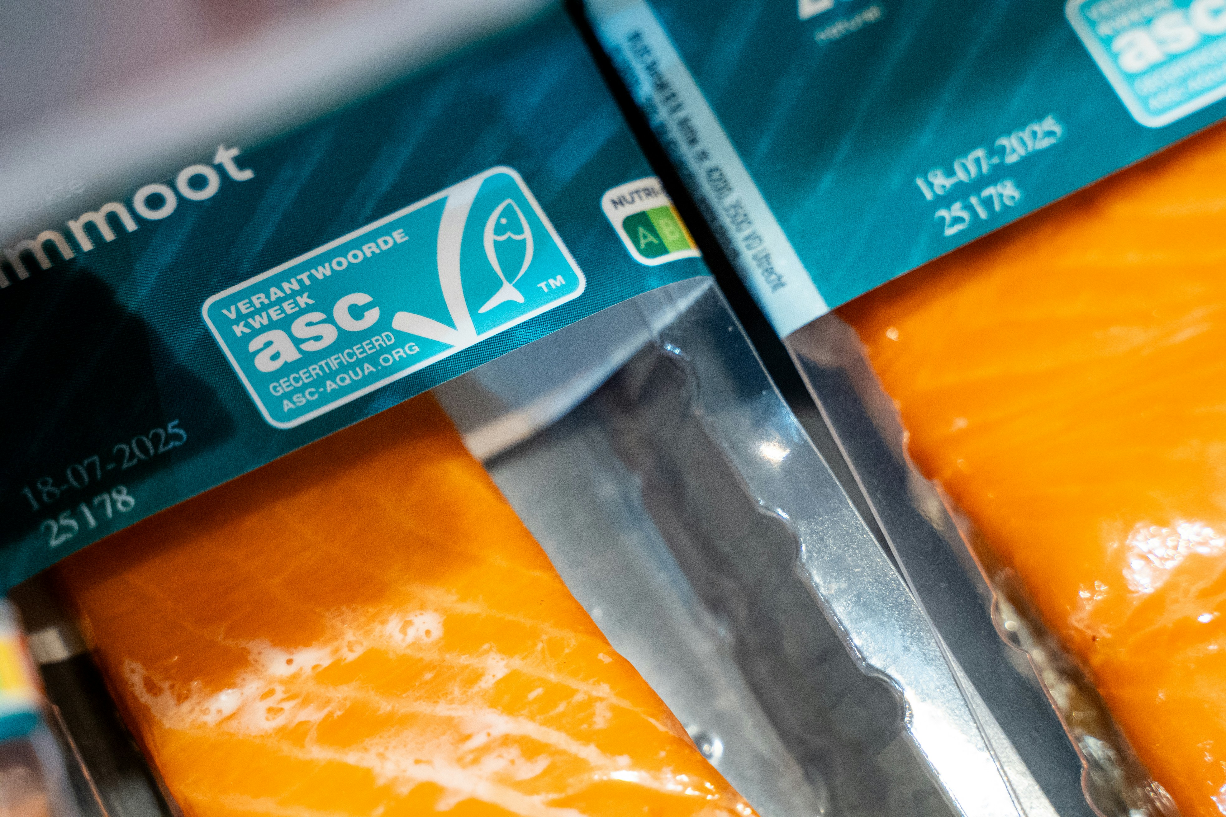 Packaged salmon fillets displaying asc certification and expiration dates.