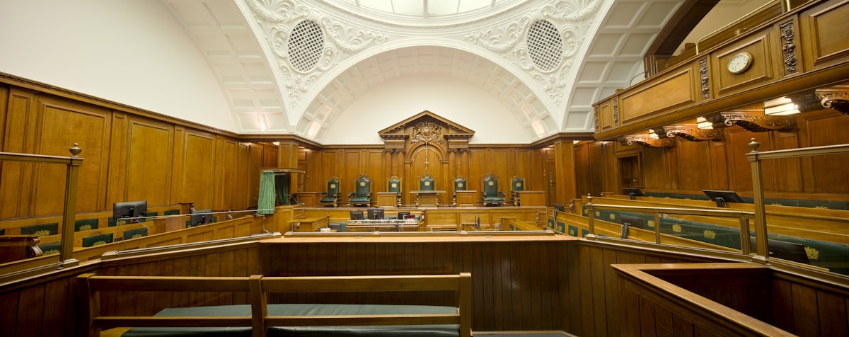 Empty courtroom with wooden paneling, representing AI tools for criminal defense lawyers in 2026