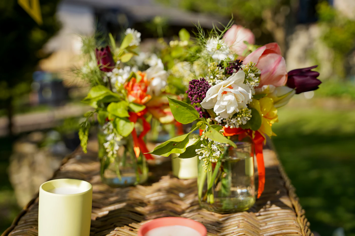Budget-friendly wedding reception centerpiece ideas — A mason jar filled with wildflowers sits on a rustic wedding table.