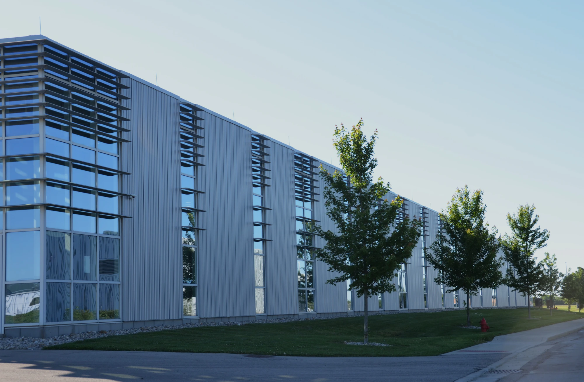 Modern commercial building with expansive windows and landscaped grounds