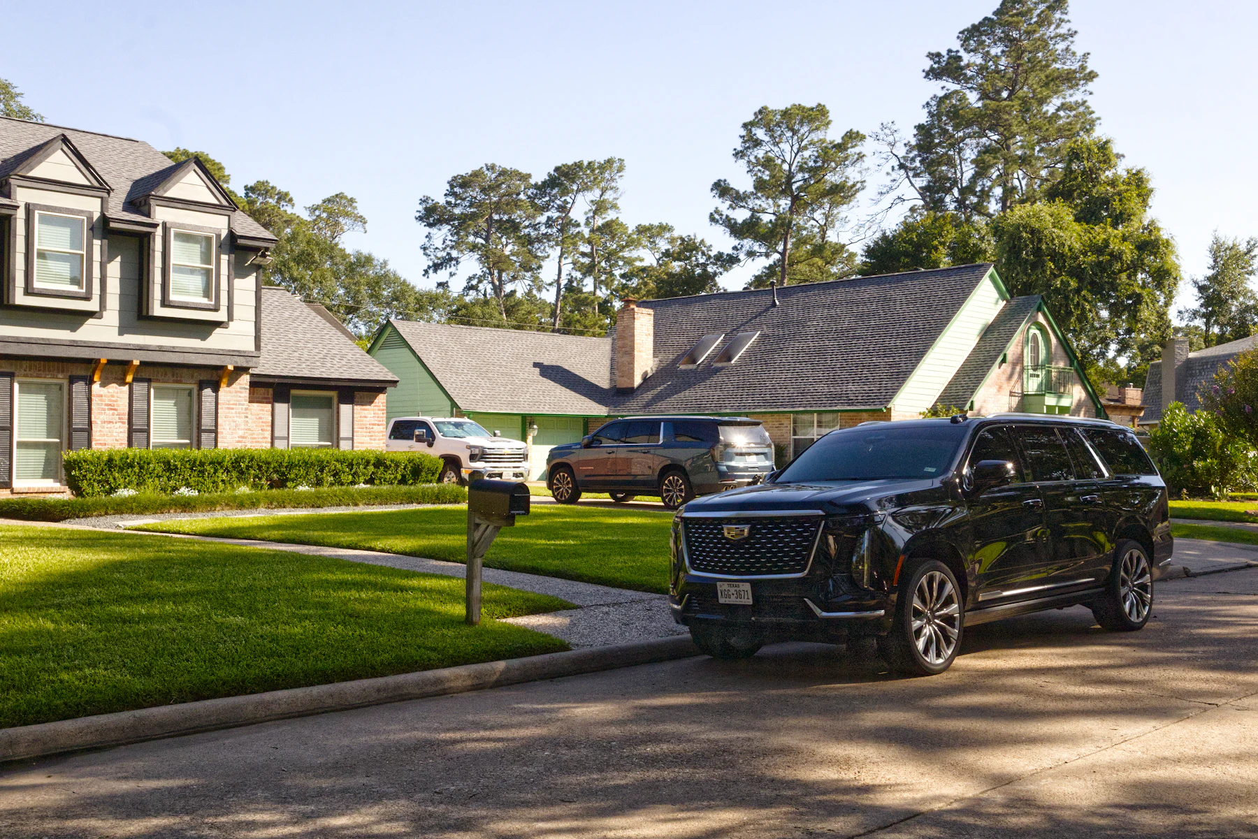Black Cadillac Escalade in the driveway of a private residence