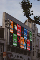 Harry styles concert posters displayed on a large digital billboard.