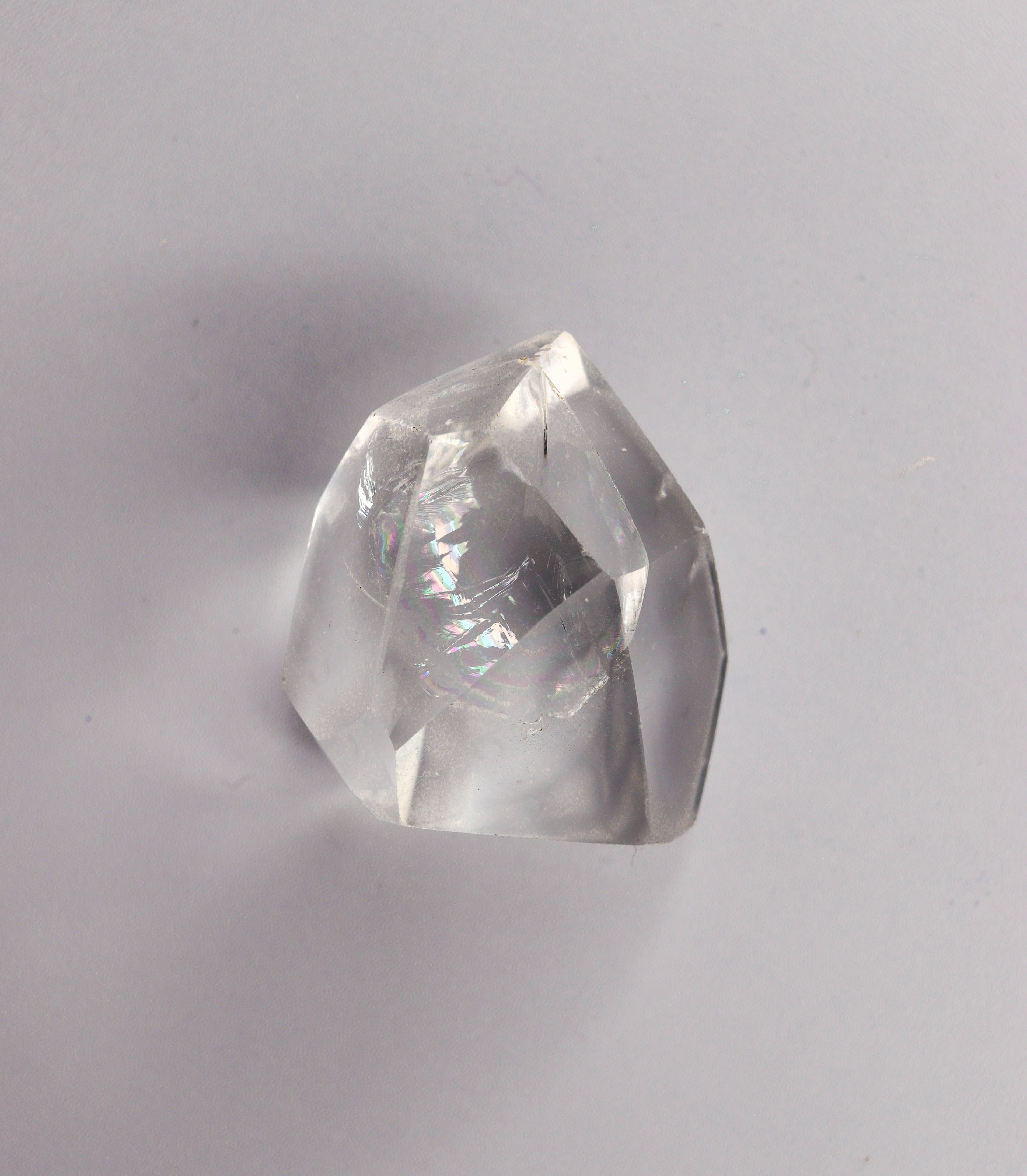 A clear, faceted crystal on a white background