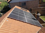Solar panels installed on a tiled residential roof.