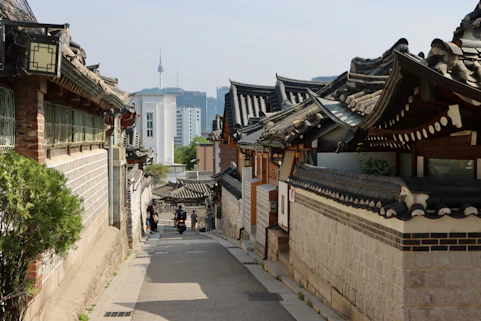 Rua estreita em vila hanok tradicional na Coreia do Sul, com casas de telhado curvo
