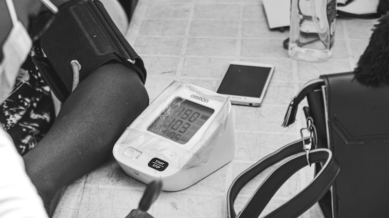 Digital blood pressure monitor taking a reading on a person's arm at home