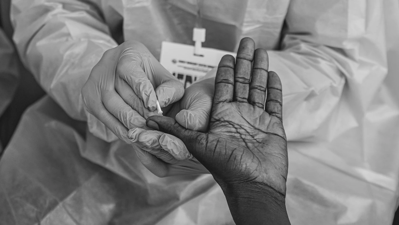 Medical professional gently holding a patient's hand
