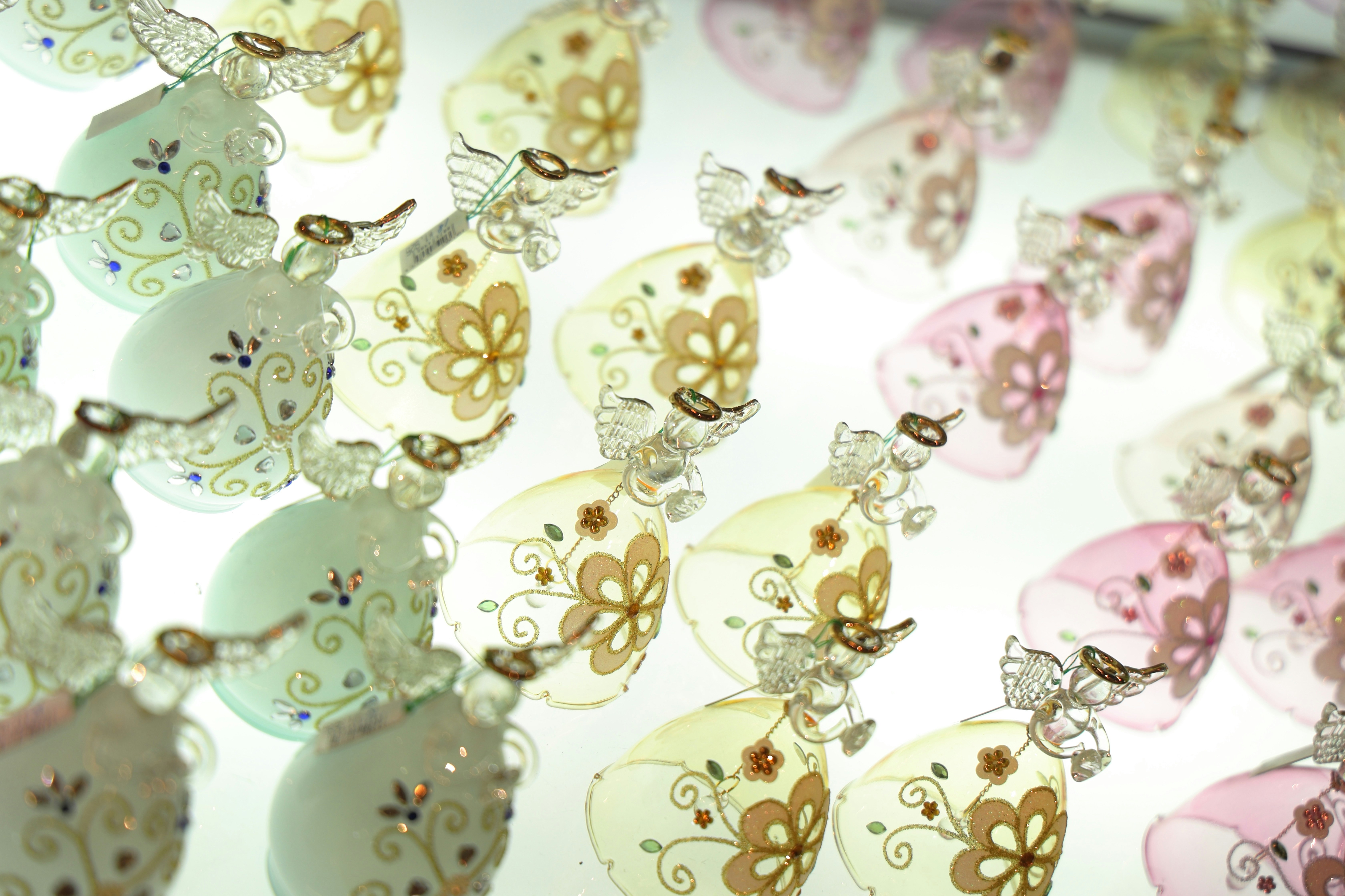 Rows of decorative glass bells with intricate floral patterns.
