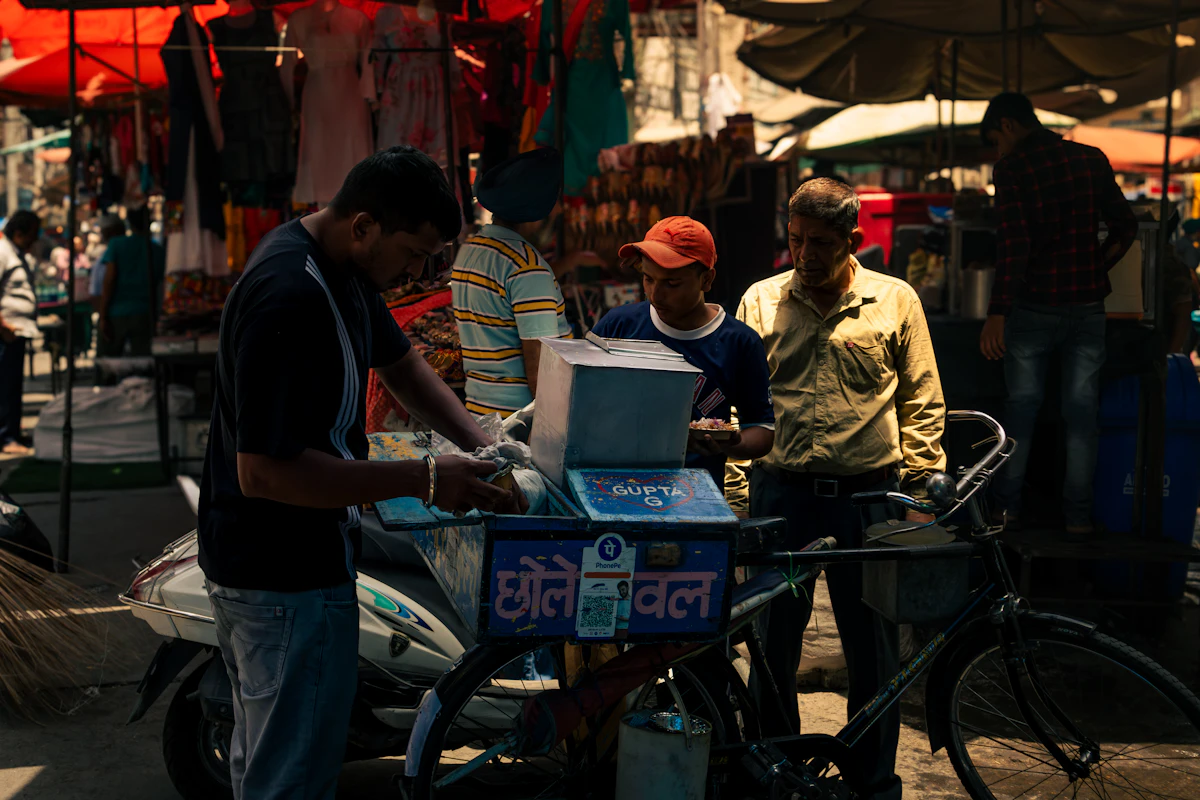 A street-market vendor weighing items at a stall in Jalandhar, Punjab